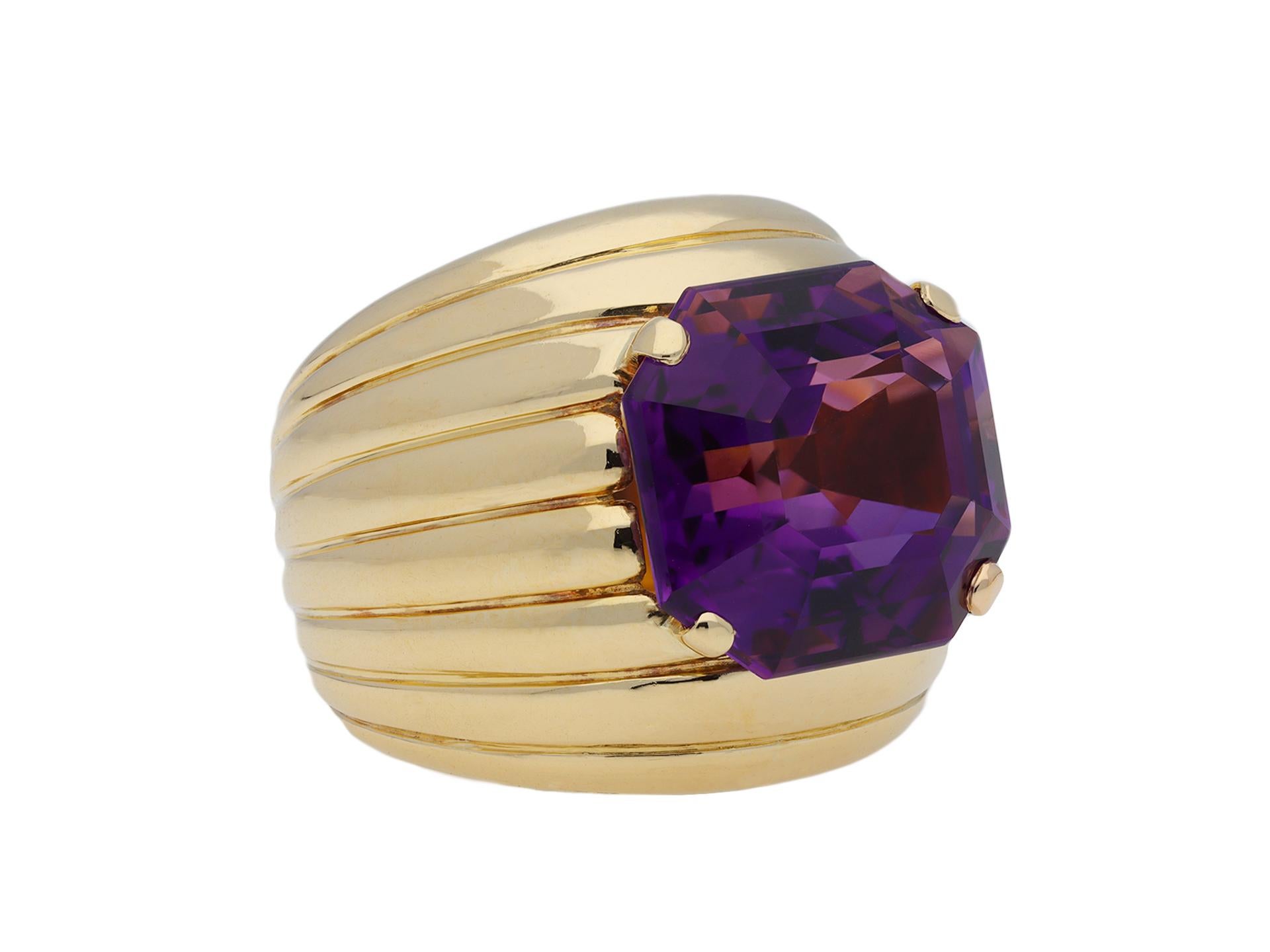 Amethyst cocktail ring. Set centrally with an octagonal emerald-cut natural amethyst in an open back claw setting with an approximate weight of 9. 46 carats, to a i bombé design featuring corner claws, ribbed details, polished borders and open
