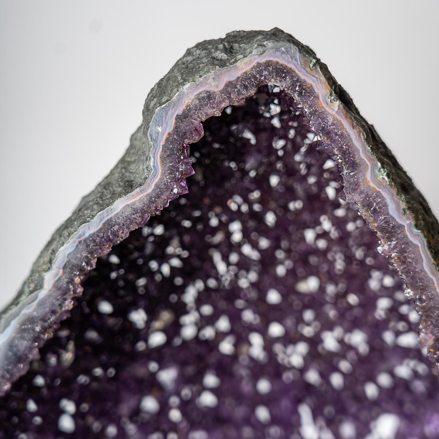 AAA museum quality, massive Brazilian Amethyst geode. This specimen is lined with large lustrous crystallized gems - transparent to translucent amethyst variety quartz crystals - with deep grape purple color and highly reflective terminated faces.