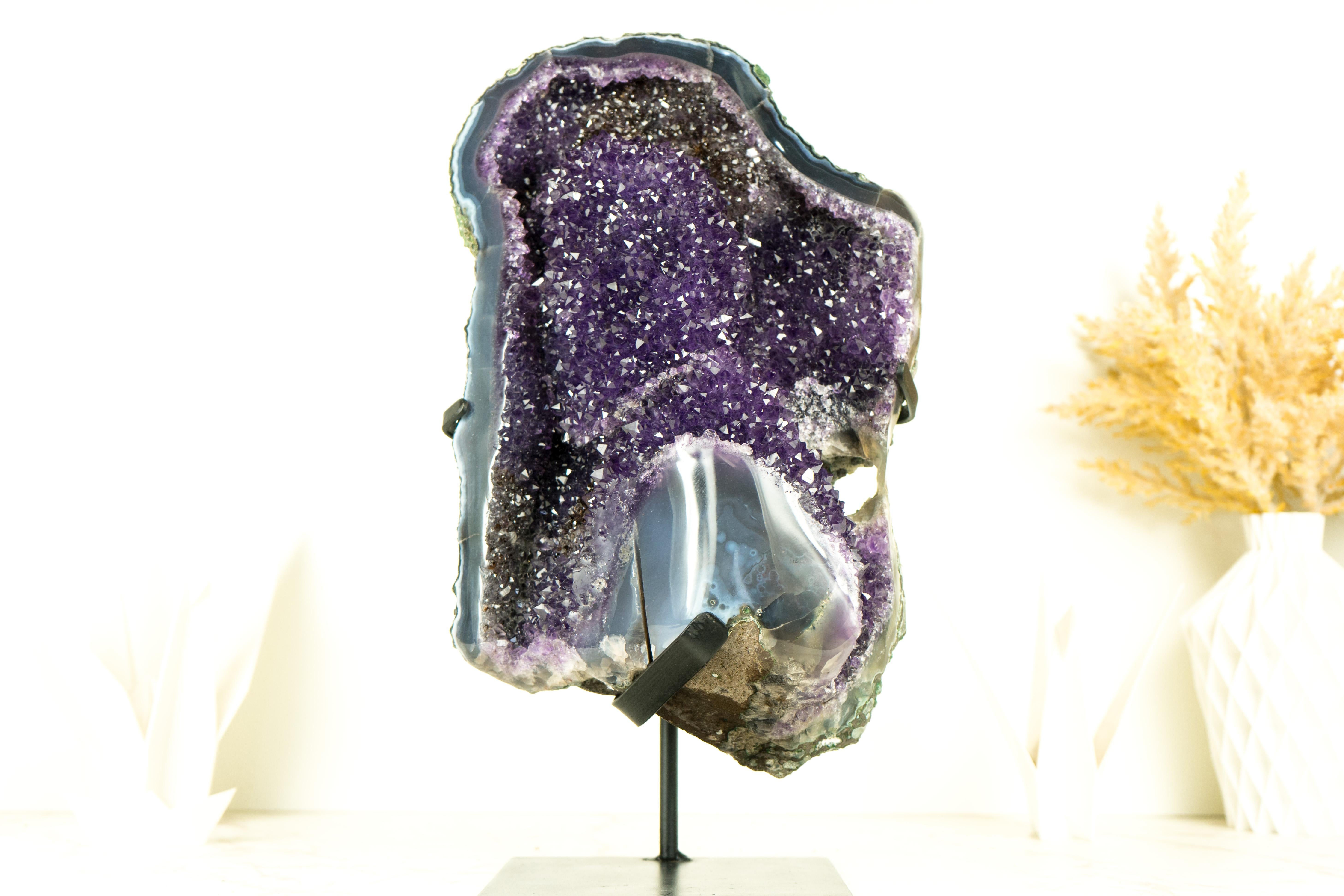 A natural spectacle, this Galaxy Amethyst Geode is art in the form of crystal. The Deep Purple Galaxy Amethyst Druzy contrasts beautifully with the ocean-blue lace agate, giving rise to a one-of-a-kind, world-class Amethyst Geode. A mineral