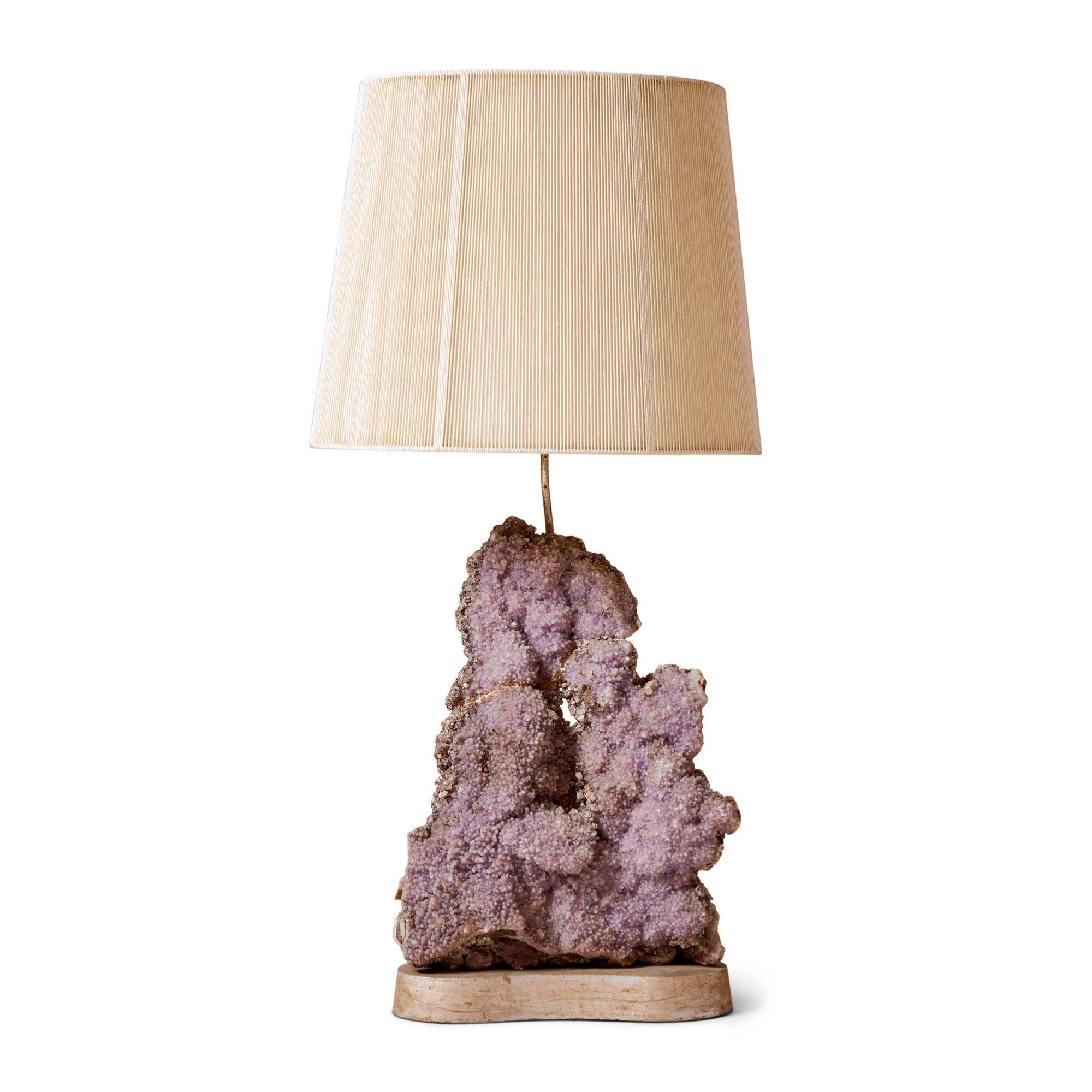 An amethyst crystal table lamp mounted on a custom gilt base.