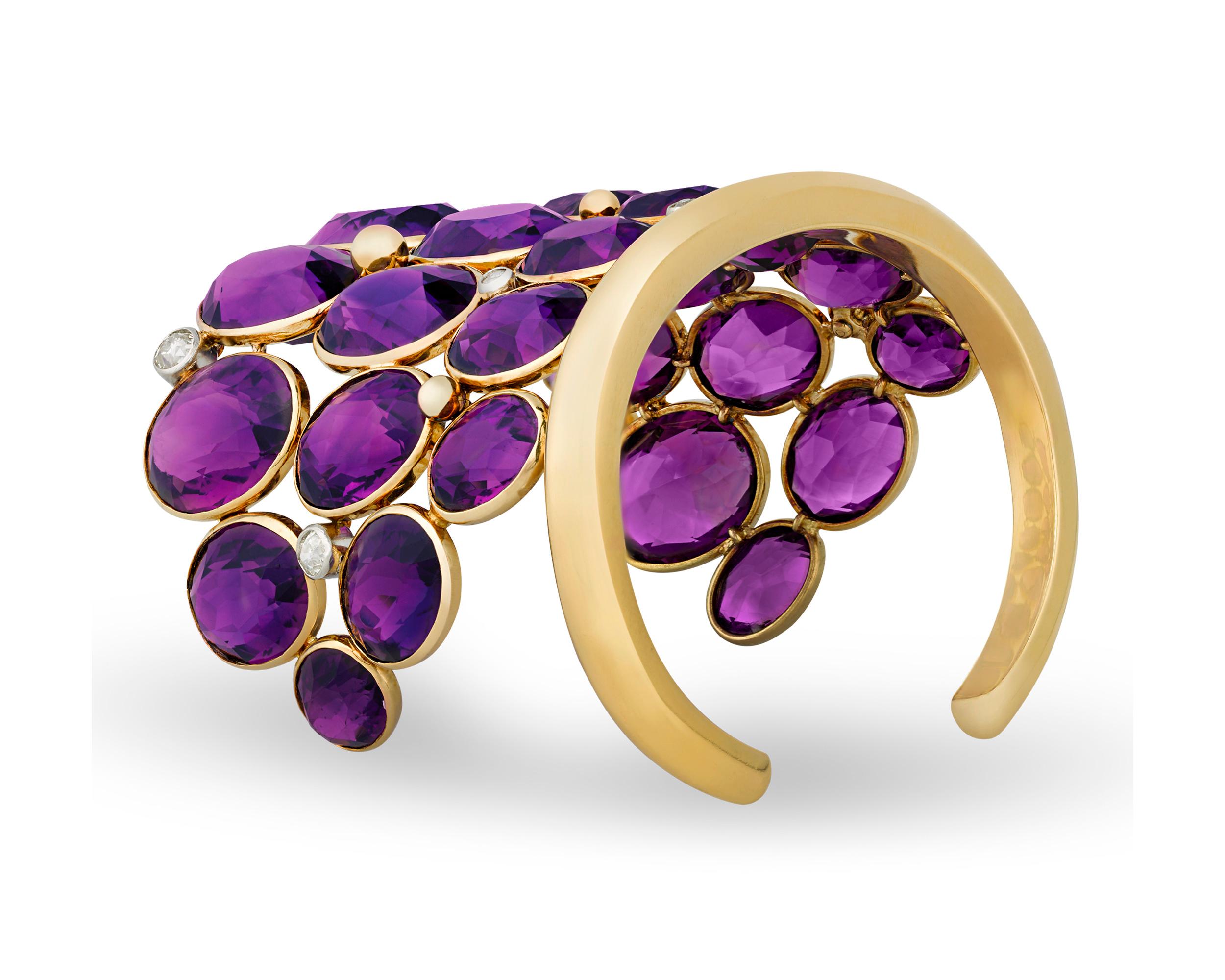 This vintage amethyst cuff bracelet displays the marvels of color from French jeweler Suzanne Belperron. The patterns and bright purple hues of the amethyst gems are complemented by the old-cut diamonds. Set in platinum and 18K yellow gold.

Suzanne