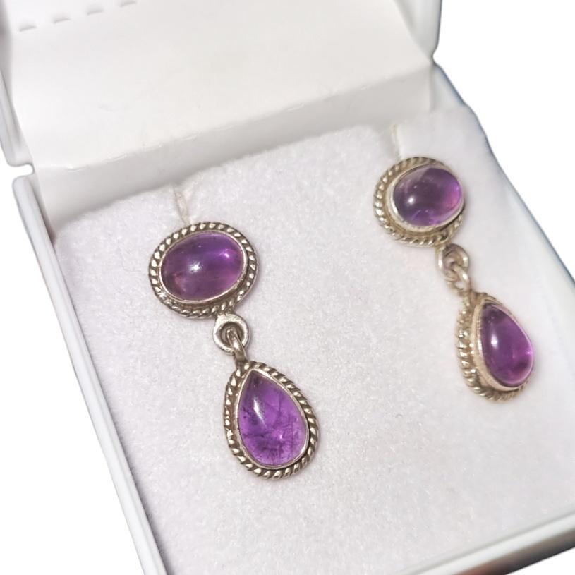 Metal - Sterling silver
Gross Weight - 4.56 Grams
Gemstones - Natural Amethyst

Introducing our exquisite natural amethyst stud earrings with dangling amethyst accents in sterling silver. These earrings combine elegance and sophistication, making