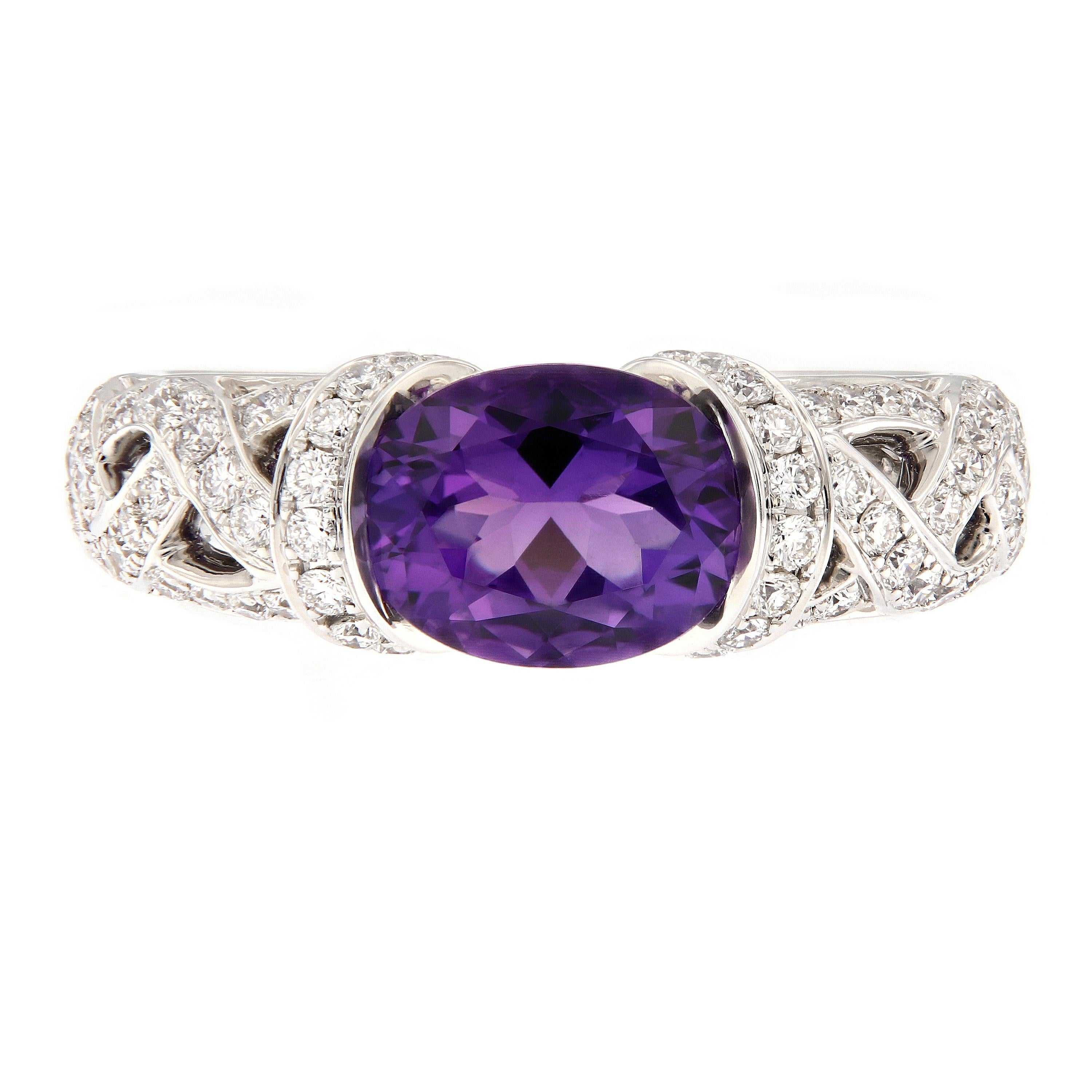 This pretty ring is comfortable and a low profile with a lot of impact. Ring features a gorgeous amethyst center stone with a crossover openwork band set with  diamonds. Ring size is 6.25. Weighs 7.5 grams.

Amethyst 1.51 cttw
Diamond 0.68 cttw