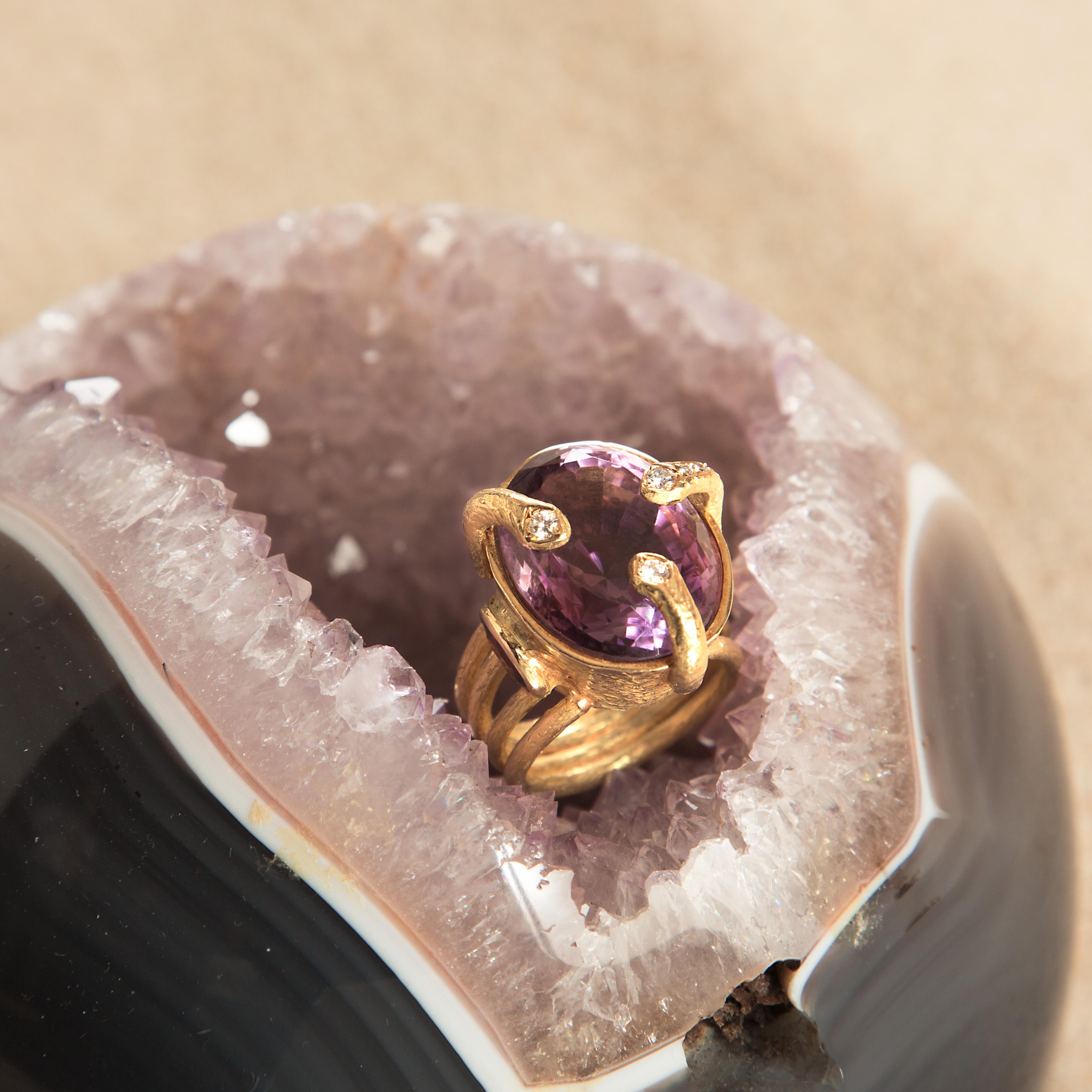 Rare and magnificent natural amethyst surrounded by a mixed 18 karat yellow gold ring embellished by three diamonds.  

This royal jewel is inspired by the power of the stones, the amethyst with a deep purple color represents the passion and