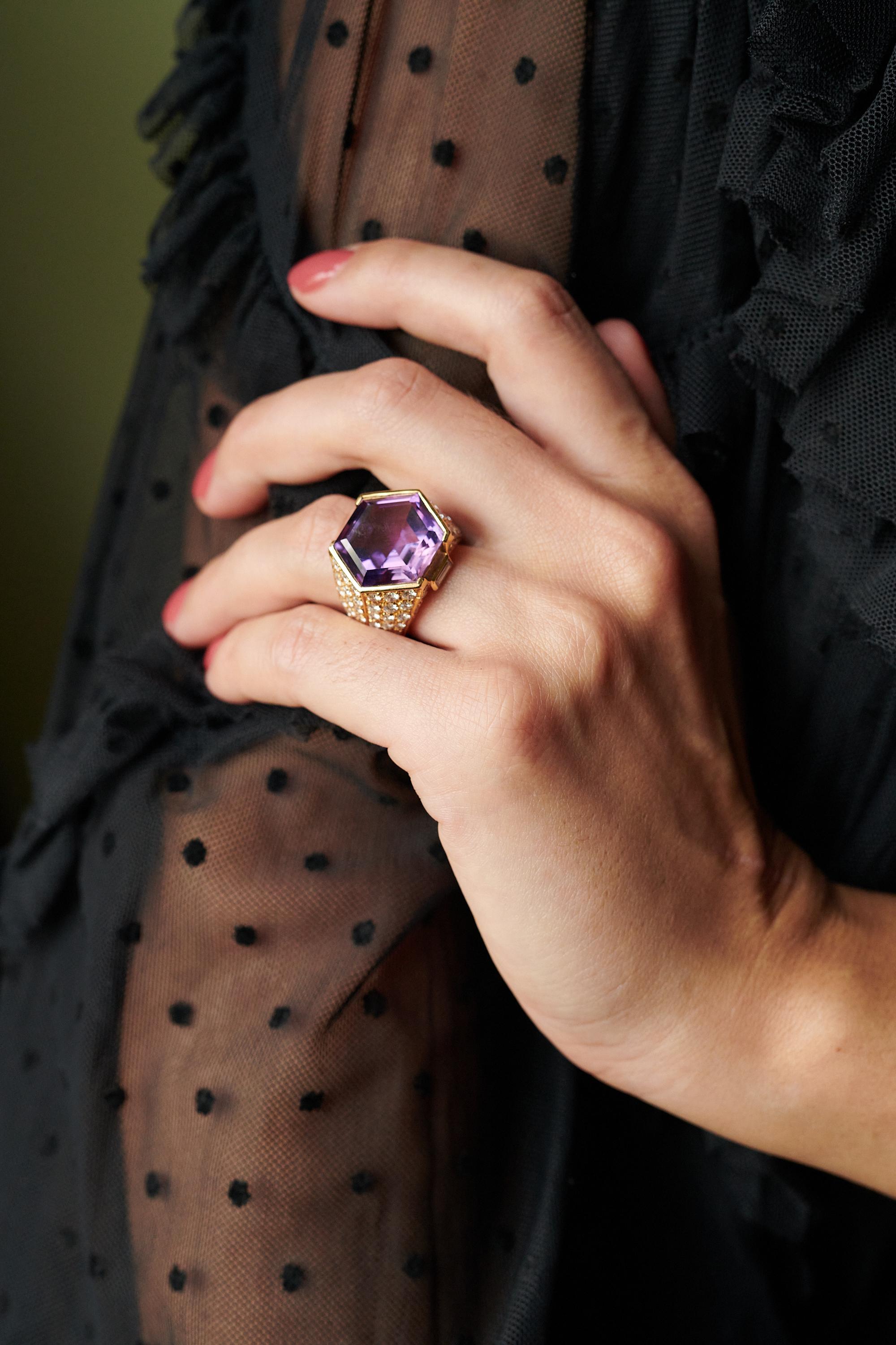 A faceted hexagonal amethyst, diamond and 18 karat gold cocktail ring. 
Diamonds weigh approximately 2.25 carats total and are colorless, VS quality. 
Ring is stamped 750, with makers mark, size 6.5. 
Absolutely stunning when worn and and