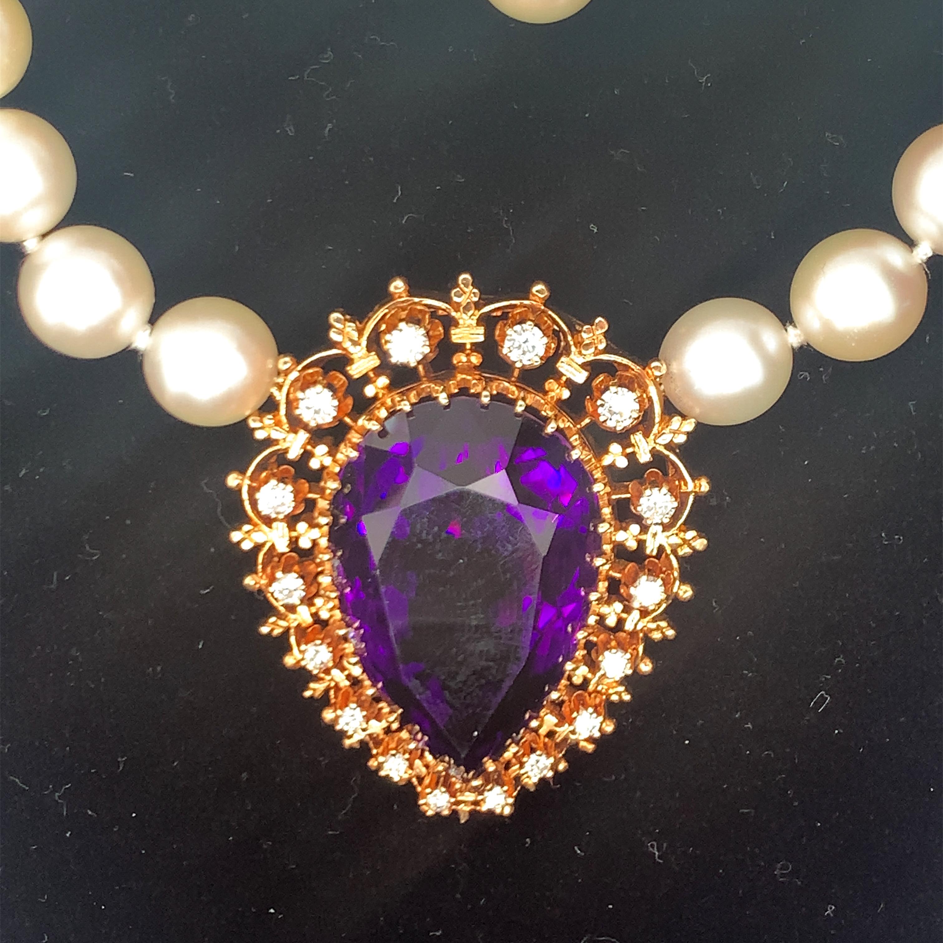 One amethyst and diamond Victorian pendant charm centering one pear shape amethyst weighing 50 ct. with sixteen round brilliant cut diamond weighing a total of 1 ct. with G color and VS-1 clarity. Attached to a modern pearl necklace featuring