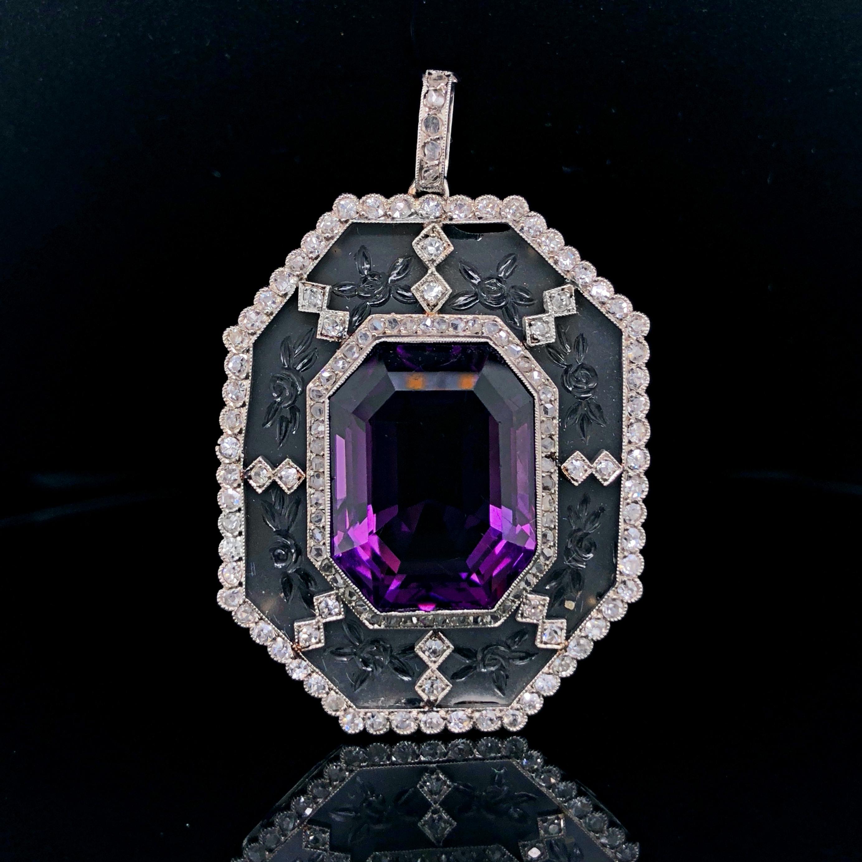 An amethyst, diamond and rock crystal pendant in platinum, France, ca. 1910s. 
The large emerald cut amethyst weighs approximately 18 carats and has a deep purple Siberian colour. It is very clean and free of inclusions, with natural growth lines
