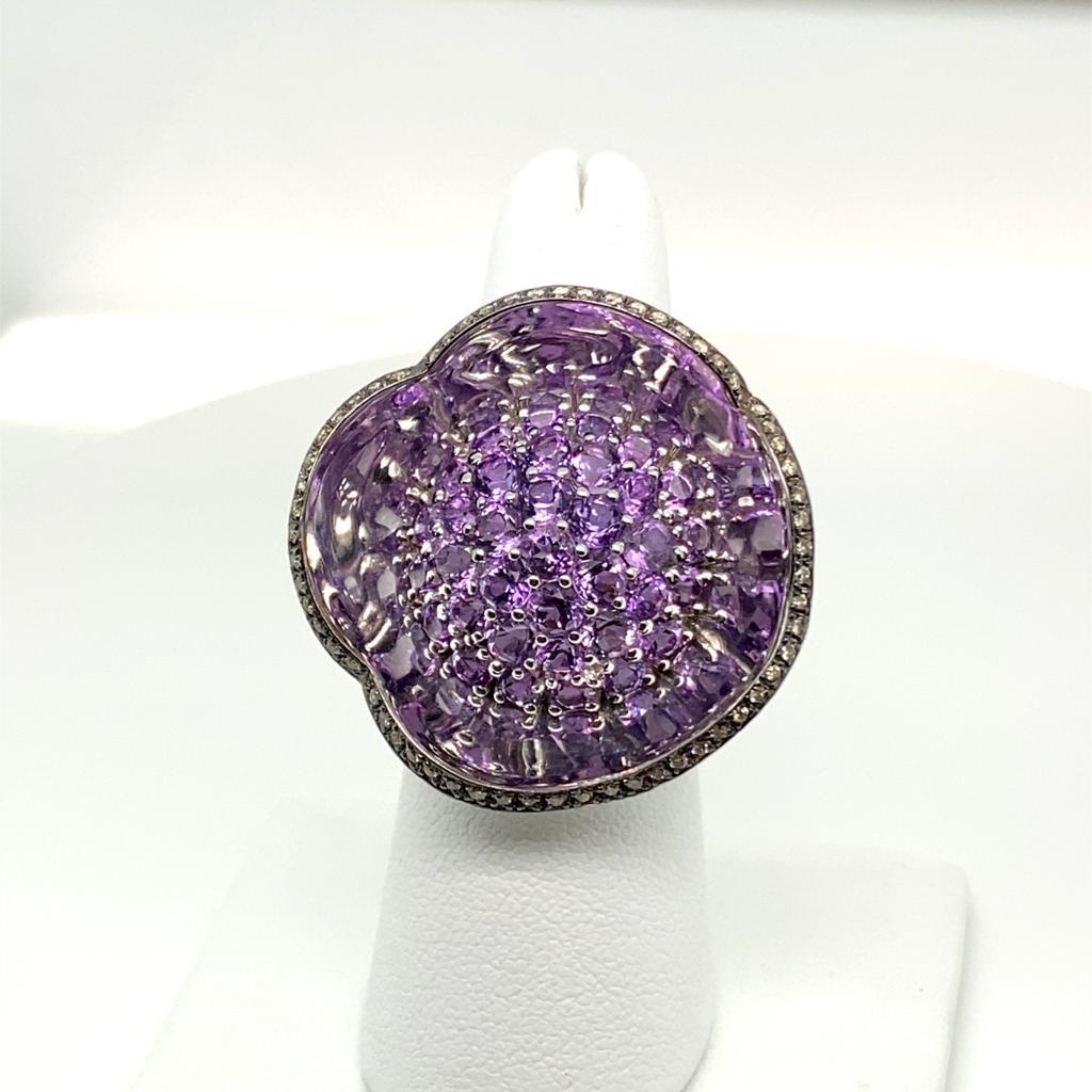 18 k white gold cocktail ring featuring 0.35 carats brown diamonds along the edge. 5 carats of Amethyst in the center. The ring is shaped to resemble a flower and has a mirrored effect. Total weight is approximately 18 grams. Ring can be resized