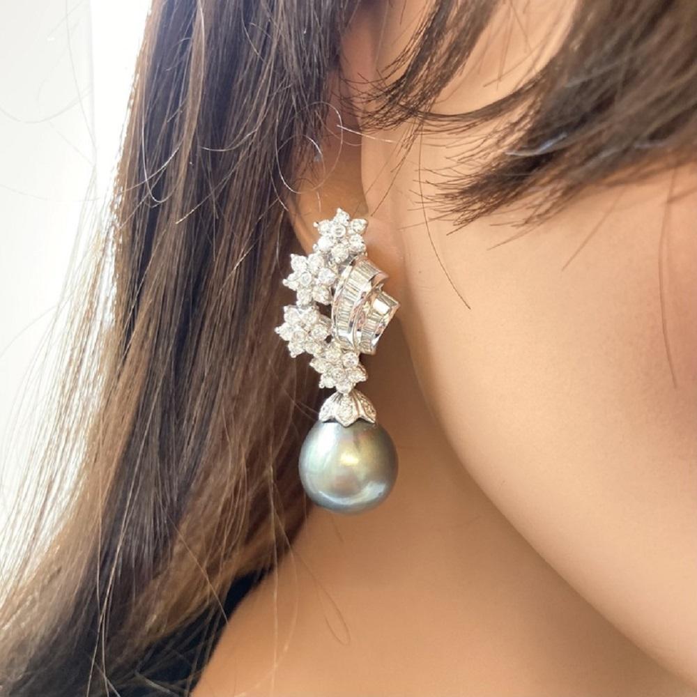 Earrings made of platinum with a round pearl as the main stone and round white diamonds as side stones can be a stunning and classic choice. Here's a description of these earrings: Earring Material: Platinum is an excellent choice for the metal,