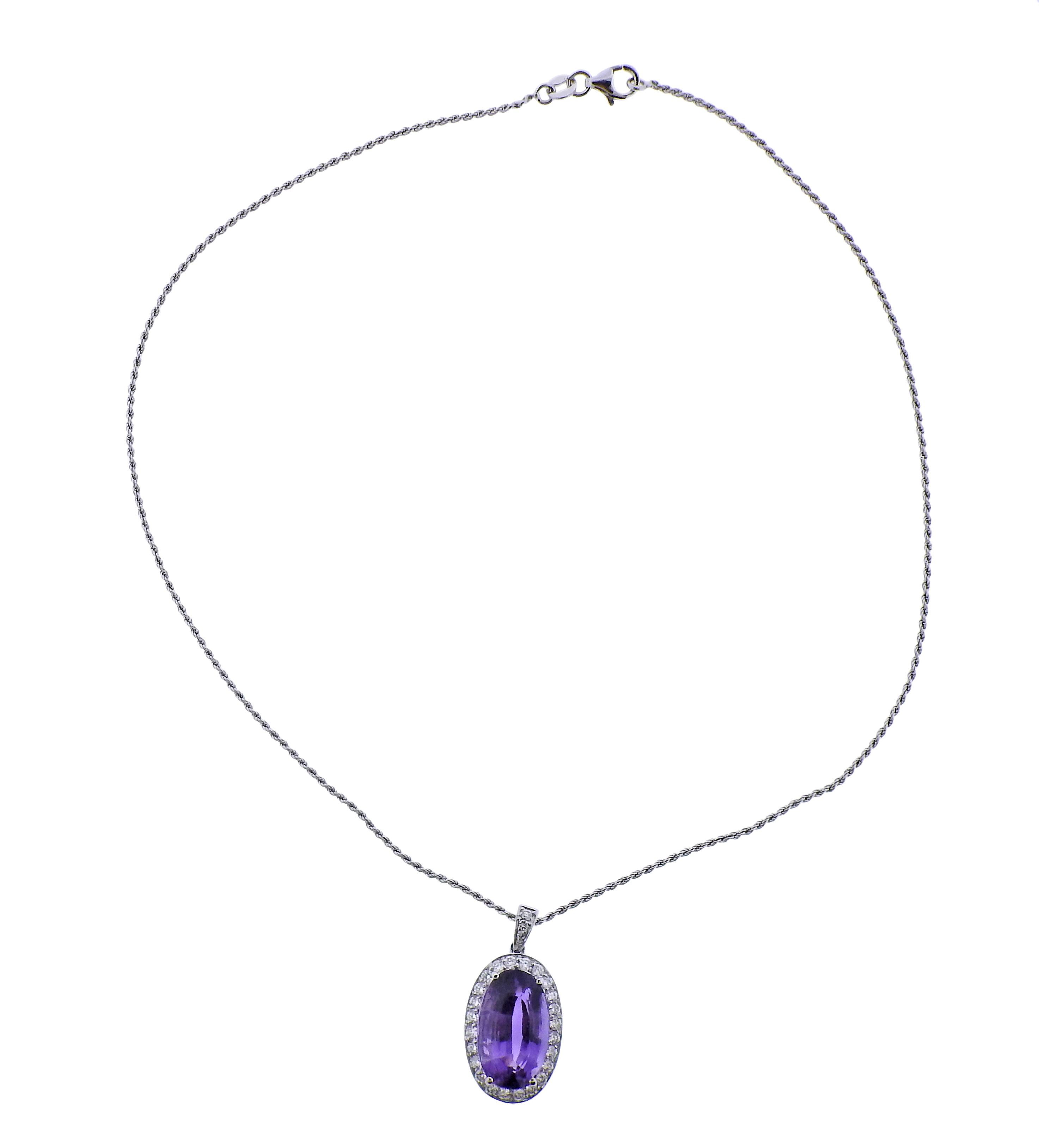 18k gold chain necklace with pendant. Set with oval 16.4 x 10.9 x 9.3mm amethyst, surrounded with approx. 0.52ctw in diamonds.  Necklace is 16