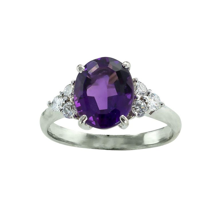 Amethyst diamond and platinum ring circa 1990. *

ABOUT THIS ITEM:  #R-DJ716E. Scroll down for specifications.  Centering upon a faceted oval amethyst between trios of round diamonds.  There is something very feminine and appealing about this ring. 