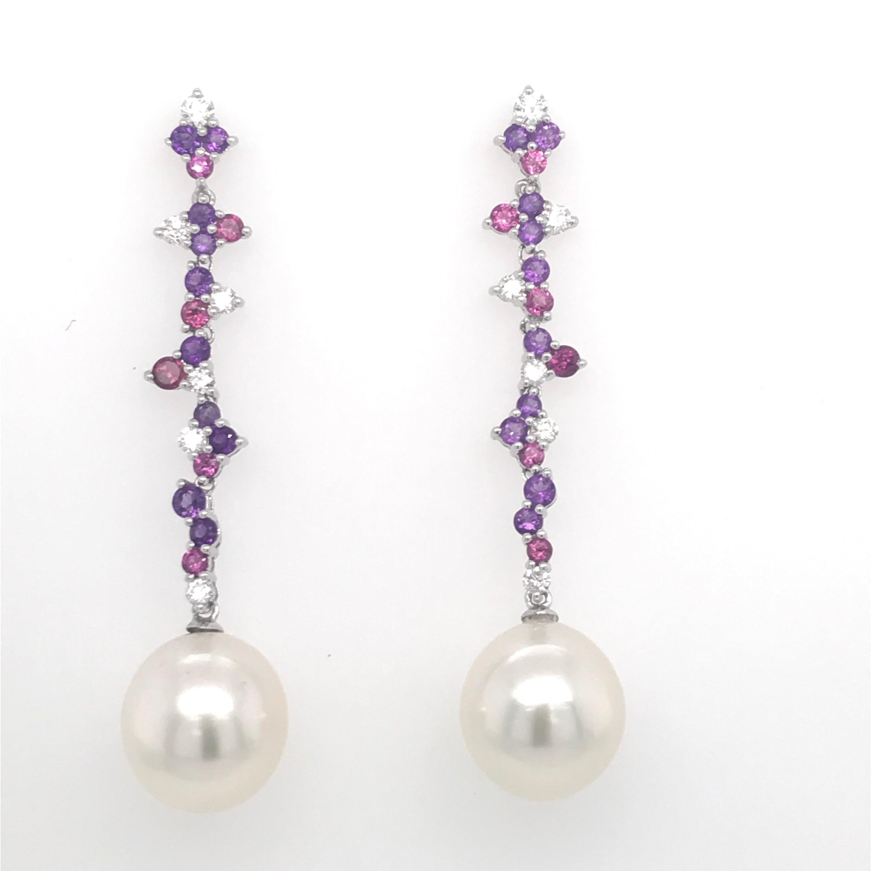 18K White Gold drop earrings featuring two pearls measuring 12-13 mm with diamonds, 0.50 carats, pink and purple amethyst & rhodonites weighing 1.60 carats. 