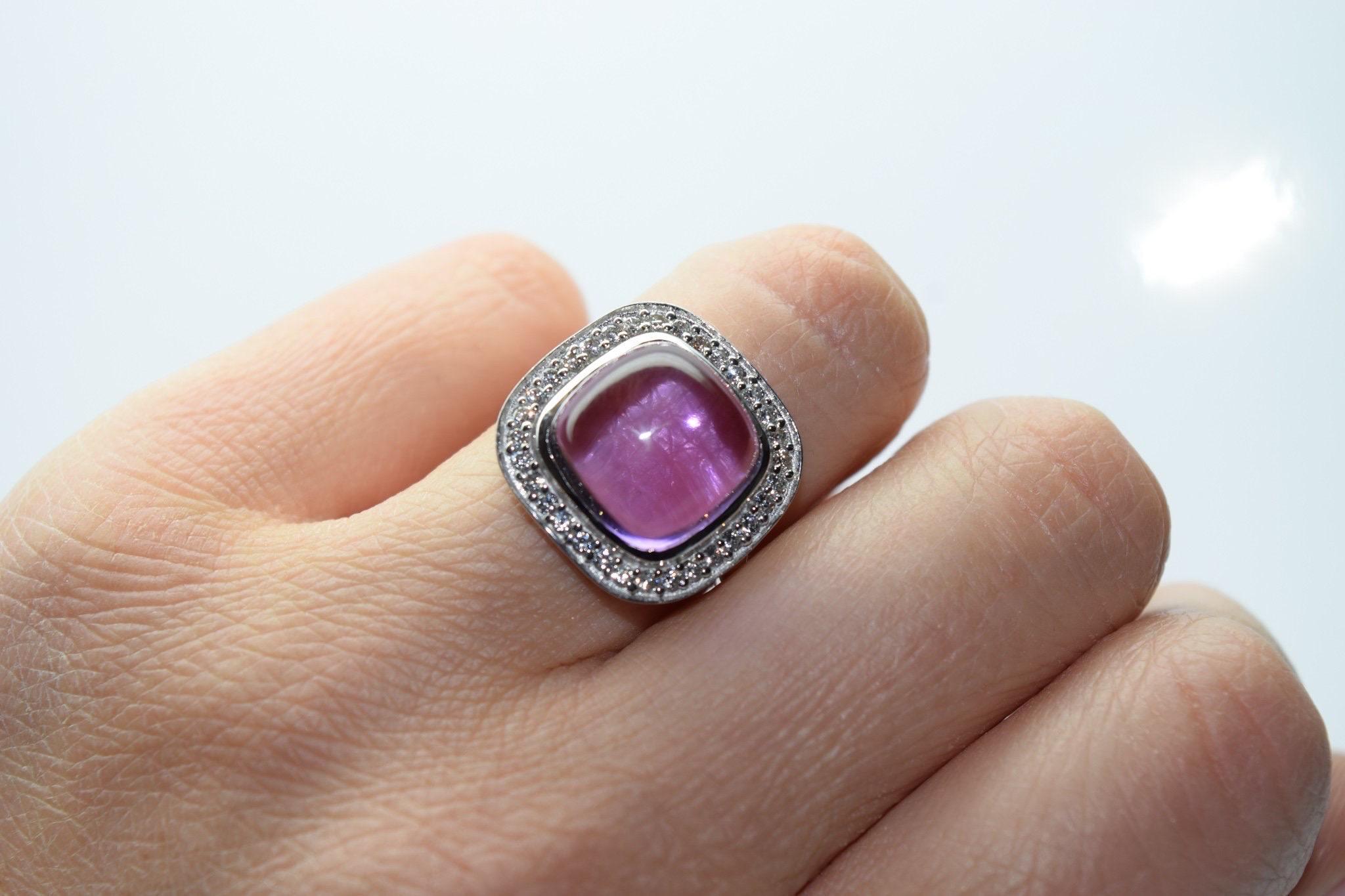 Amethyst cabochon with diamonds all around in a modern cocktail ring in 114kt white gold.

Certificate of authenticity comes with purchase!

ABOUT US
We are a family-owned business. Our studio in located in the heart of Boca Raton at the