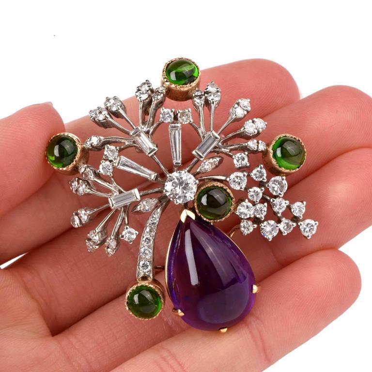 This aesthetically alluring brooch pin is crafted in a solid 14K white and yellow gold, the latter applied to colored gemstones settings. It weighs 22.5 grams and measures 2 long x 1.9