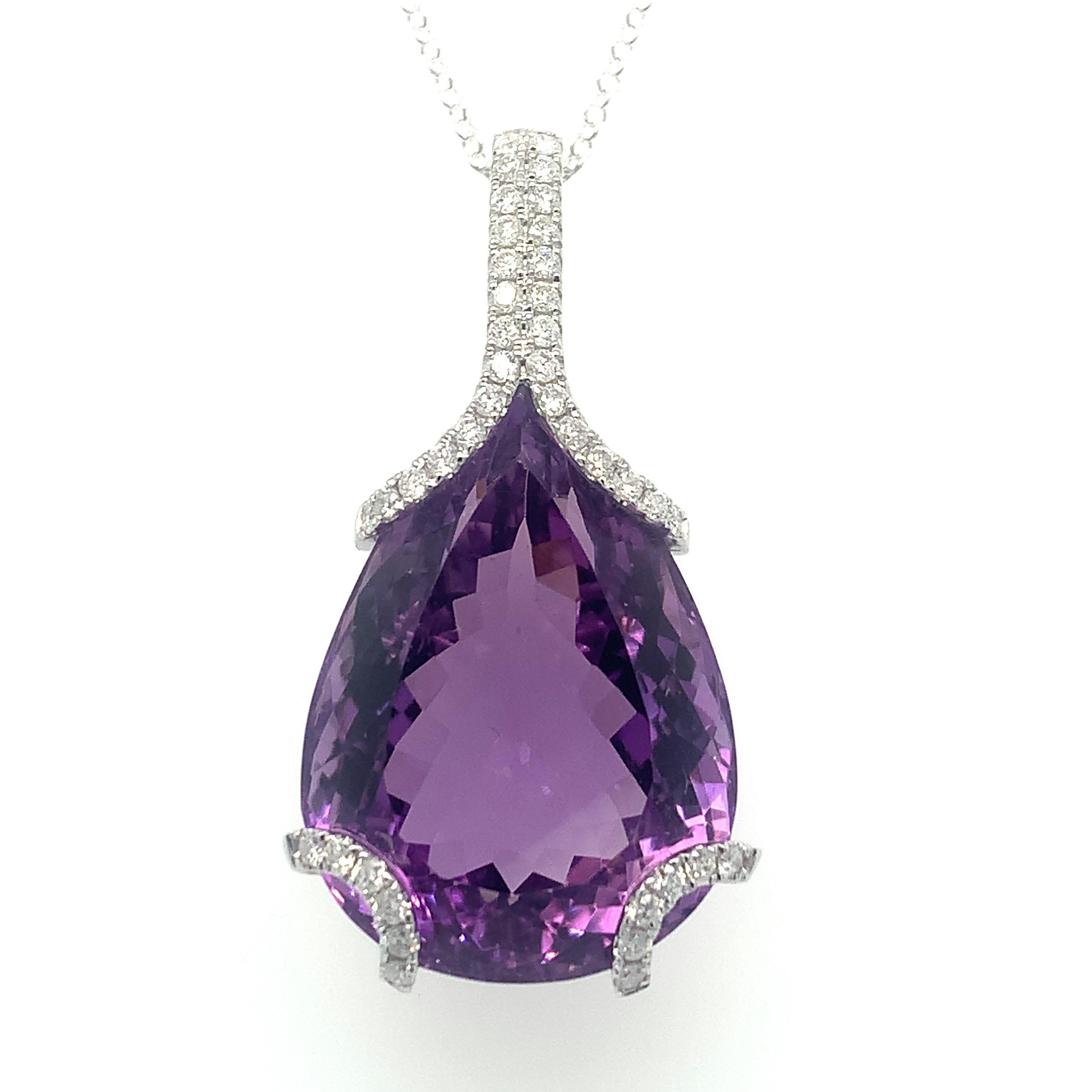 Exceedingly feminine natural amethyst pendant dazzles with the richness of its diamond details on prongs. Artistically crafted design boasts elegance and modernity. Hand cut and polished amethyst makes this piece an exceptional piece of