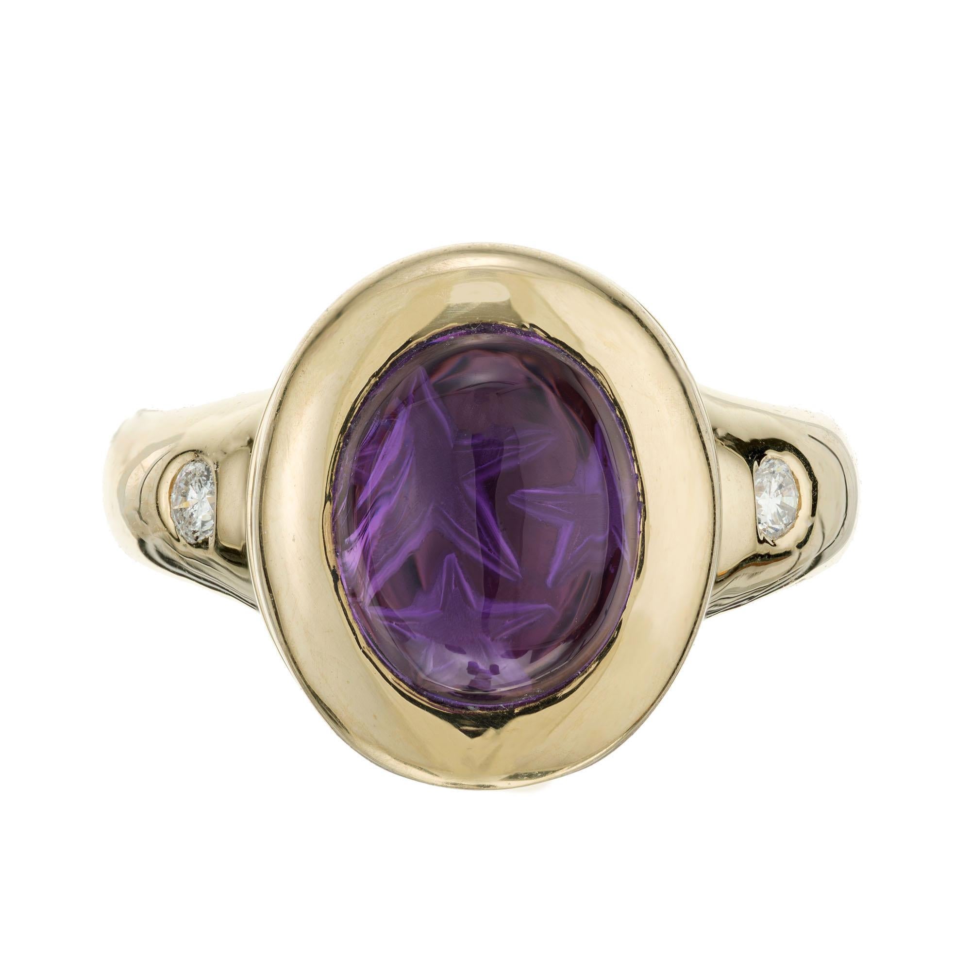 Amethyst and diamond ring. 1 oval cabochon amethyst set in 14k yellow gold with 2 round brilliant cut diamonds. Crown of ring opens up.  

1 oval cut cabochon purple amethyst, VS 10.5mm x 8.5mm
2 round brilliant cut diamond, G SI2 approx.