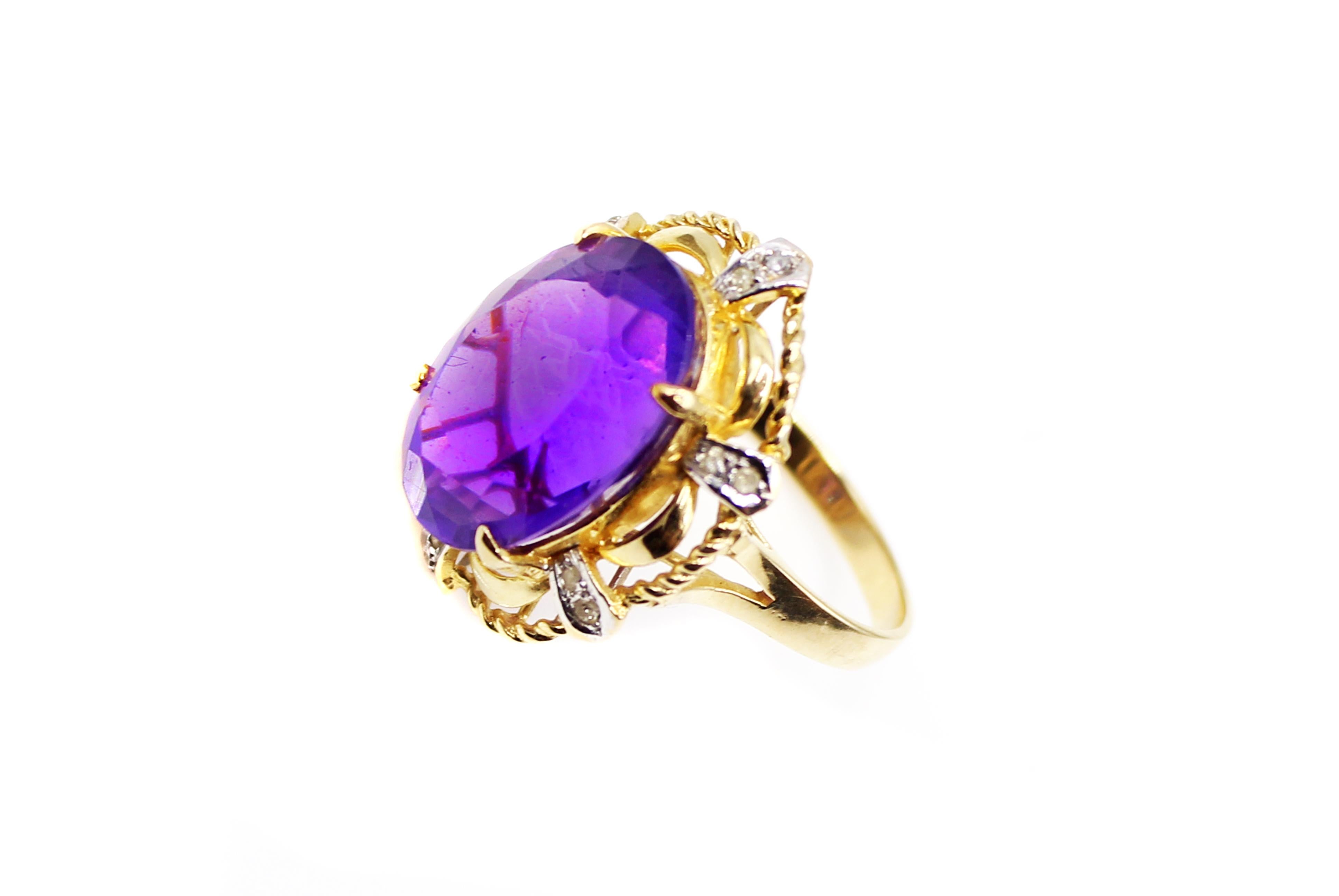 Vibrant deep purple oval cut amethyst centrally prong set surrounded by 12 small diamonds. The amethyst has been measured to weigh approximately 7.5 carats. The beautiful hand-crafted mounting was designed with 6 scallop-shaped sections of polished