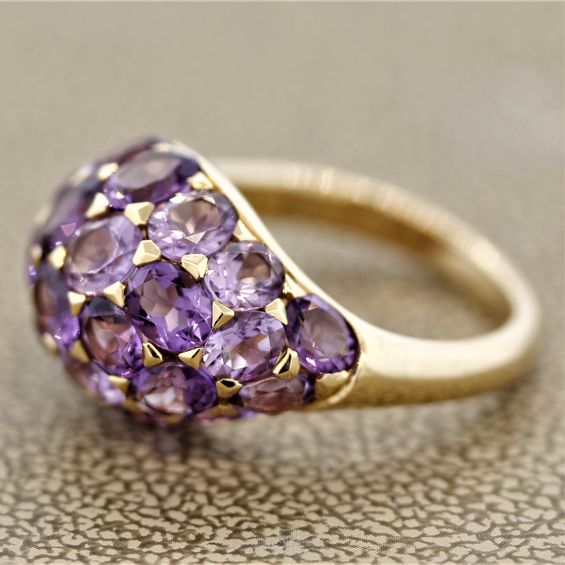 A sweet domed ring featuring bright purple amethyst! They are cut as oval shapes in various sizes and weigh a total of 5.24 carats. Set in 18k rose gold and ready to be worn.

Ring Size 6.25