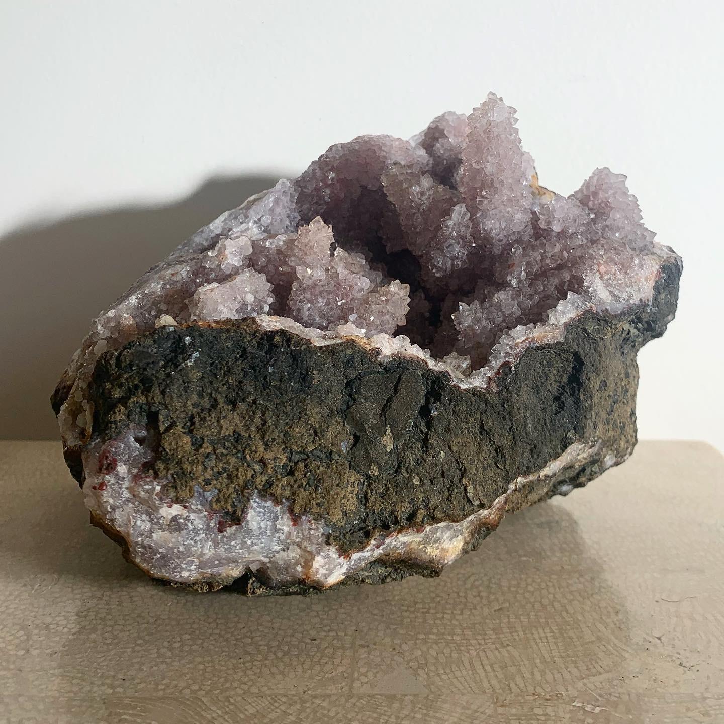 ANCIENT ENERGY: semiprecious cracked geode spilling out glorious amethyst array cradled in rough basalt. This is a TRUE rock formation sculpted from the erupted cleaving of earth many millions of years ago. The true vintage. From the Bel Air estate