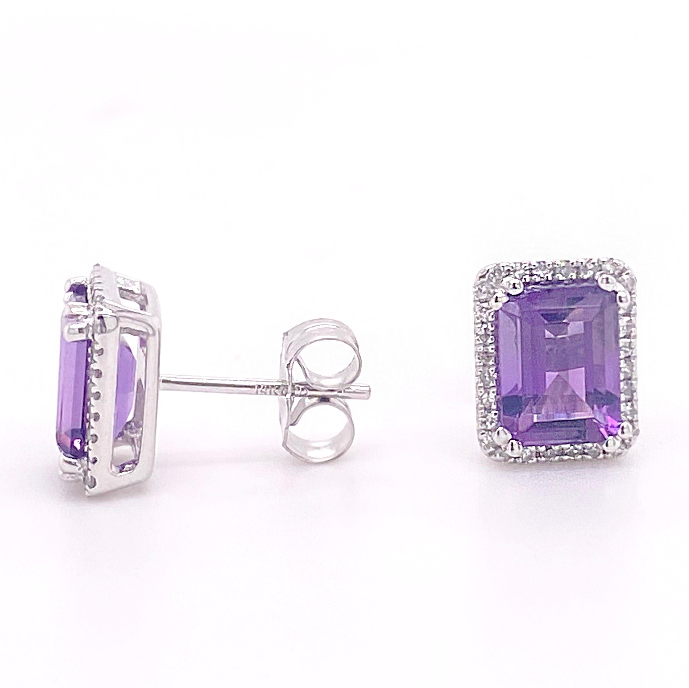 These gorgeous stud earrings have an emerald cut amethyst in the center and is surrounded by 28 natural diamonds. The halo diamonds is a perfect accent for the purple amethyst. Our jewelers have designed these earrings to go in your center piercing