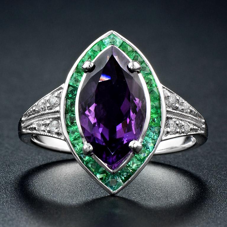 The Art Deco style ring that we have unique Marquise Amethyst size 7x14 mm. 1.35 ct. set on the center. Surrounding with fine cut Emerald (good grade and good color matching) 26 pcs. 0.82 ct. On each side, the ring set with tiny round Diamond 1.5