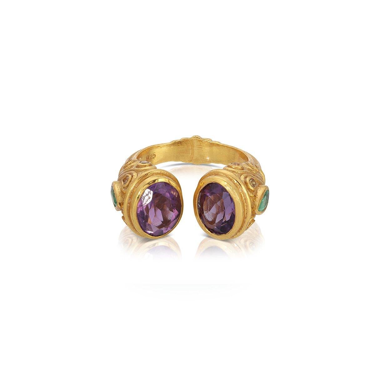 A contemporary interpretation of the opulent jewelry style of the Moguls... An Amethyst and Emerald ring featuring an open ended band tipped with luminous purple Amethyst and set with pear shaped and smaller cirque Emeralds on the side of the