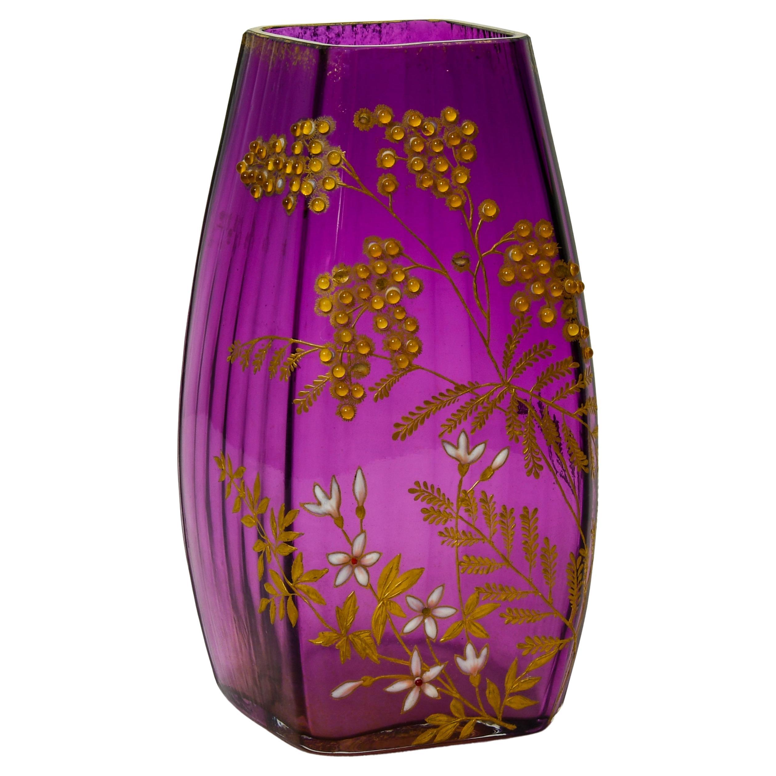 Rare and important vase in amethyst glass, exquisitely painted in gilt enhanced with enamelling and glass beads. The painted design of a Mimosa branch in bloom extends to three sides of the vase. The gilt painting is enhanced with glass beads and