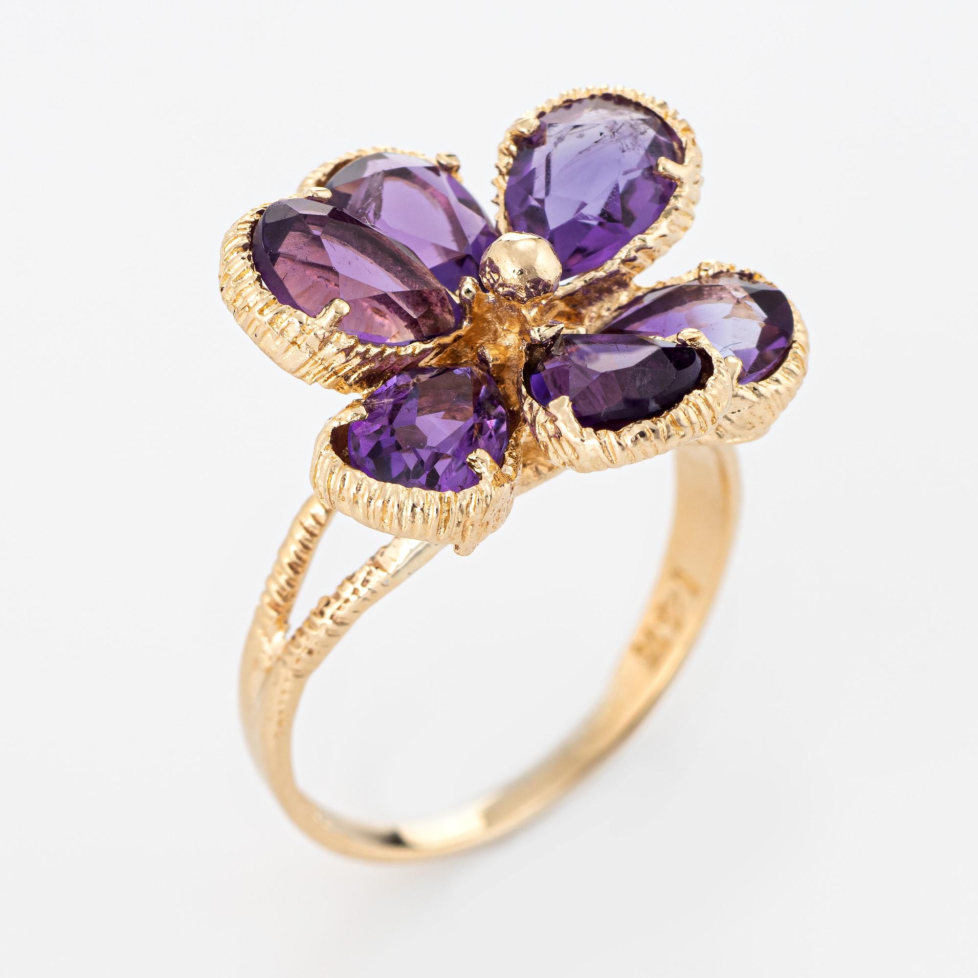 Stylish amethyst cocktail ring crafted in 14 karat yellow gold. 

Faceted pear cut amethyst measures 6mm x 4mm (estimated at 0.50 carats each) and total an estimated 2.50 carats. The amethysts are in excellent condition and free of cracks or chips.