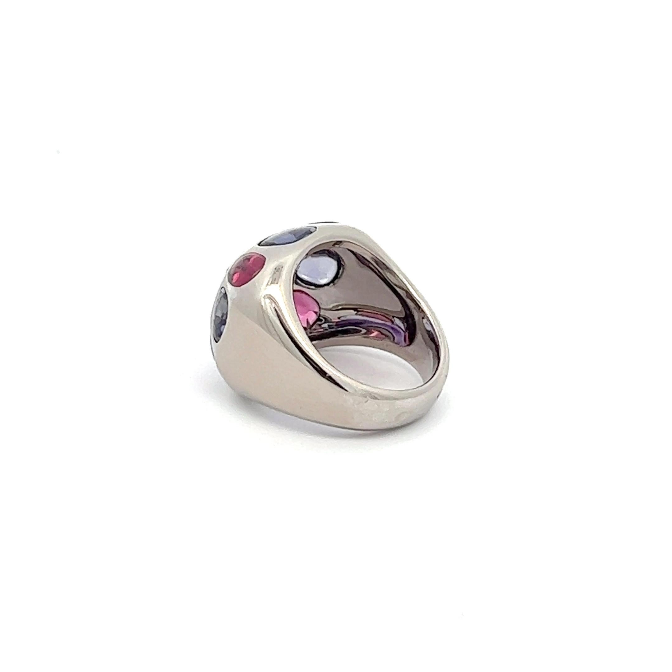 An 18ik white gold ring by Chanel.
The ring is set with Amethyst, Garnet and Iolite. 
The ring is size 52 and can't be resized.
The ring was made in France in the 1990s.
The ring is hallmarked with the French hallmark for 18k gold and French makers