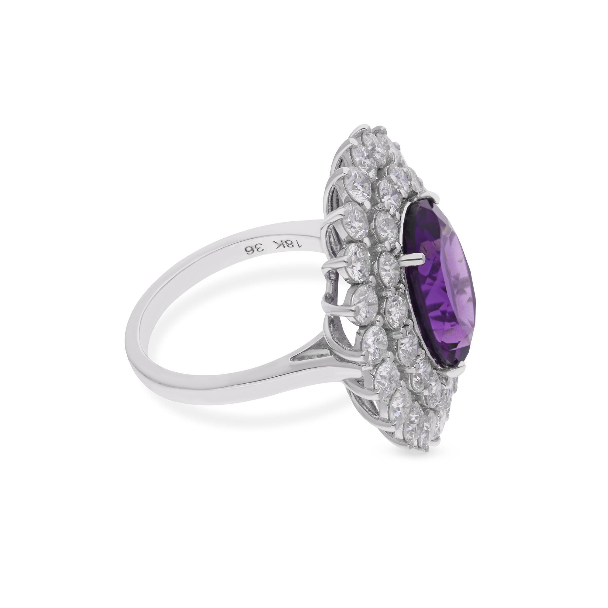 At the center of the ring rests a captivating amethyst gemstone, renowned for its mesmerizing purple hues and captivating brilliance. Surrounding the amethyst are dazzling round-cut diamonds, delicately hand-set in a luminous 14 karat white gold