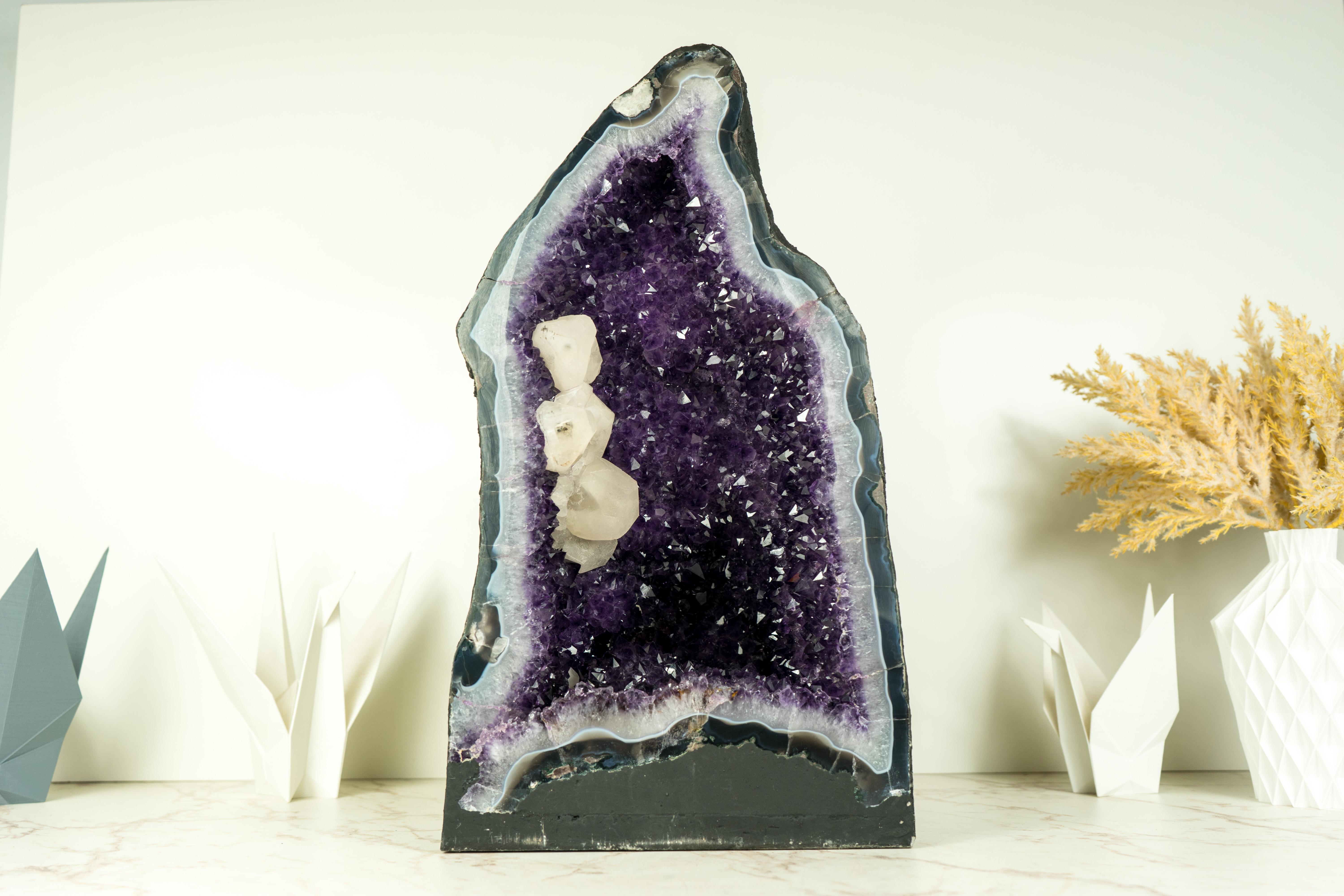 A geode that stands as an impressive natural sculpture, with calcite, deep purple, and shiny amethyst, and an aesthetical calcite inclusion interlacing that forms a unique display of natural artistry, a centerpiece.

Rarely seen in any Amethyst