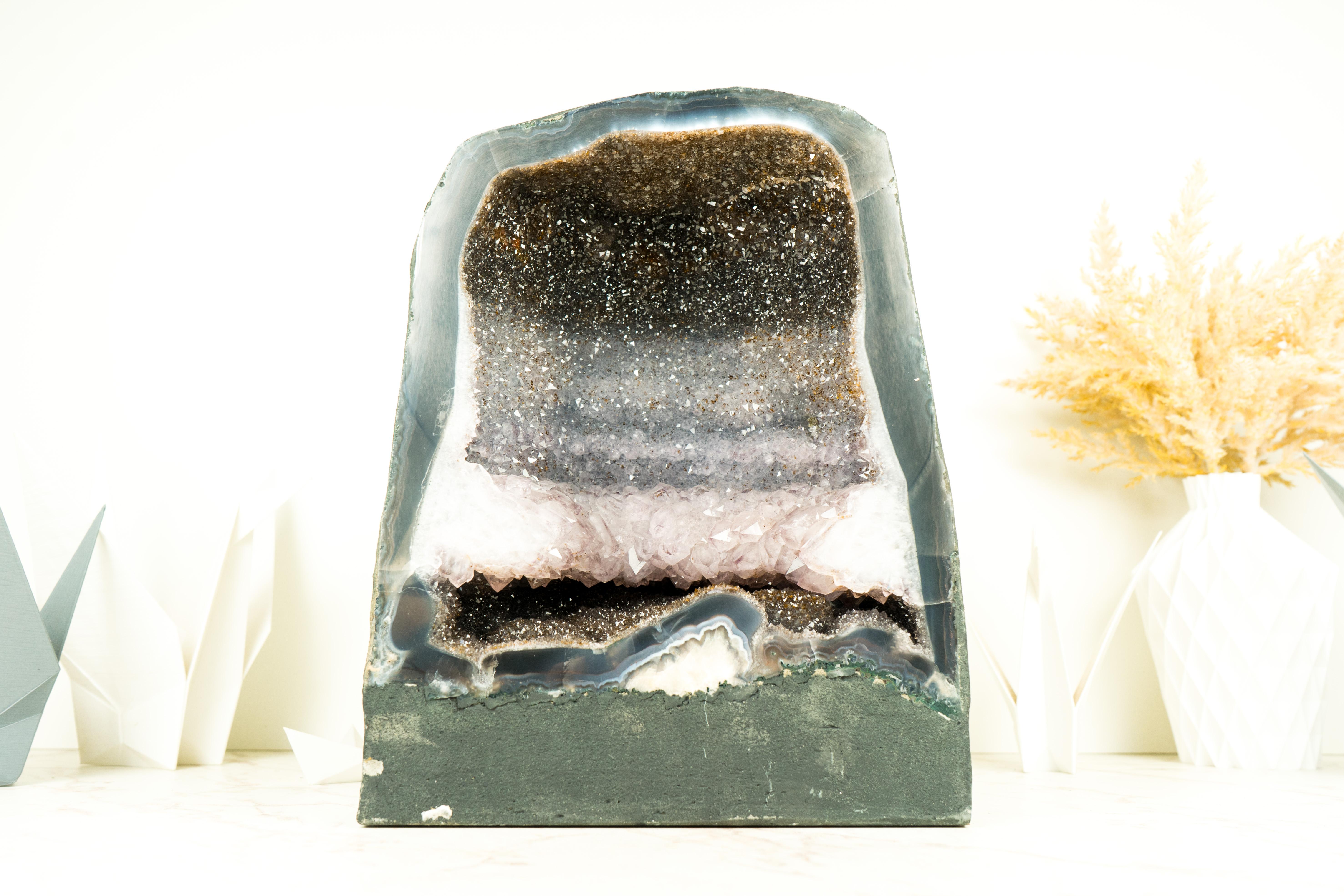 An Amethyst Geode showcasing a superb formation, with three different colors, galaxy druzy, and a striking Amethyst crown, is sure to be the conversation starter in your home decor, blending rarity with a touch of metaphysical elegance and