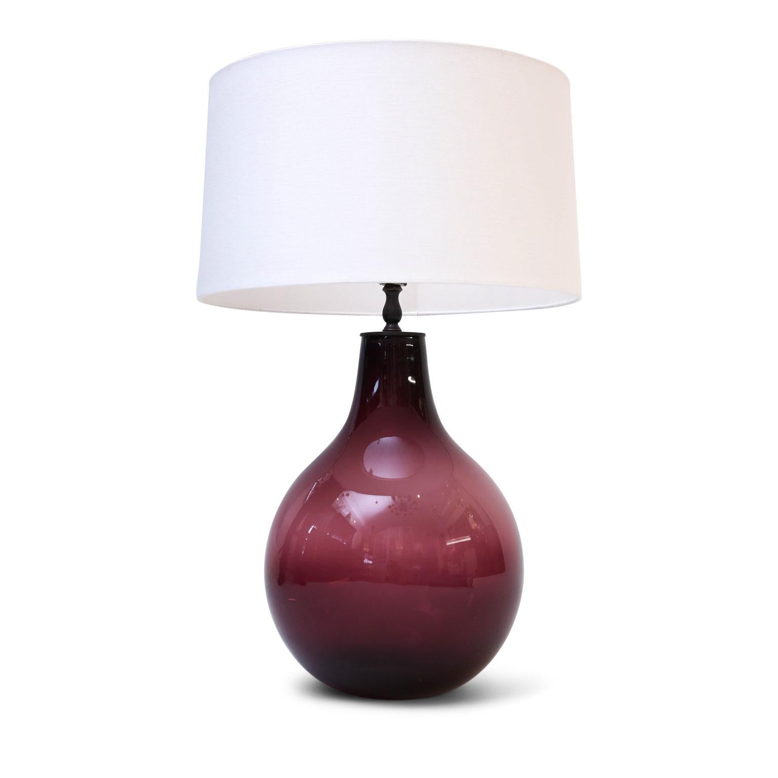 Amethyst glass lamp, from antique dark amethyst color glass bottle. Newly wired for use within the USA using all UL listed parts. Includes complimentary linen shade (listed measurements include shade).