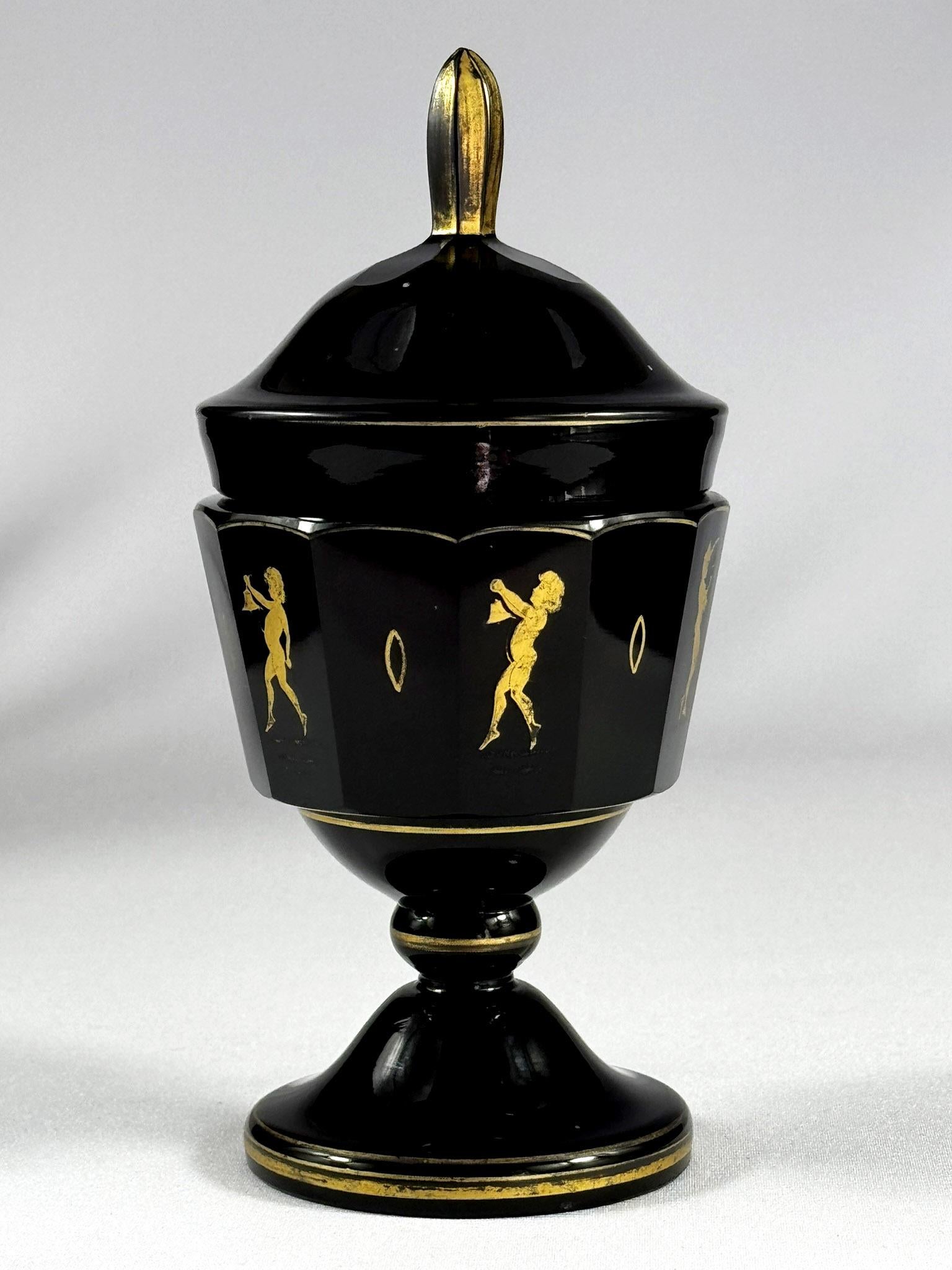 The amethyst glass goblet, hand-blown and cut, also hand-painted with gold, is twelve-sided. Alternately, a figurative motif is painted in the Art Nouveau style. This is most likely a production of the Moser company ( Bohemian Glass ) in the 20th
