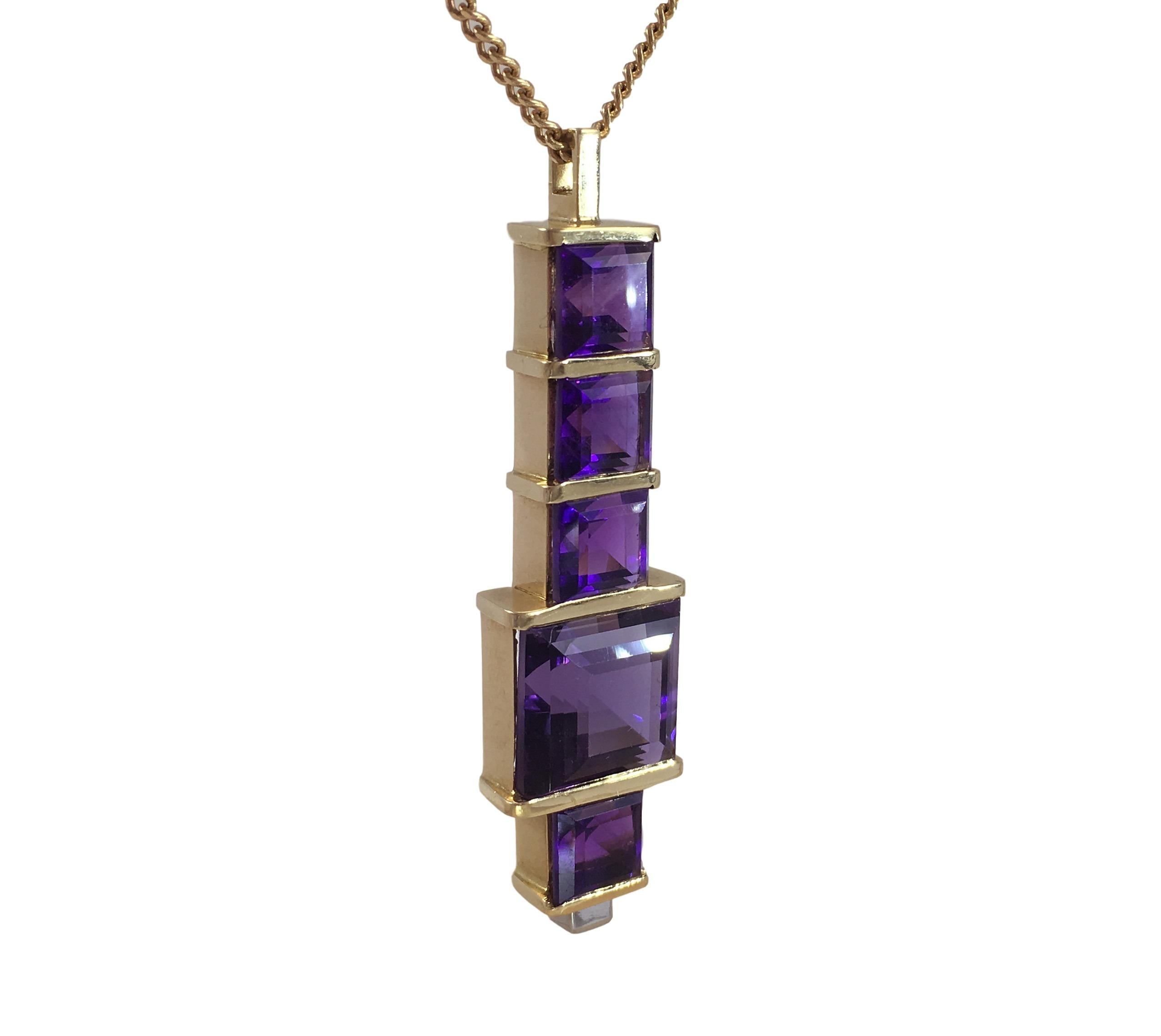 An 18 carat gold pendant set with five square step cut amethysts with a deep saturated pinkish-violet colour tension set between gold bars. The base of the pendant is set with a single square step cut diamond with E-F colour and VVS clarity.

The