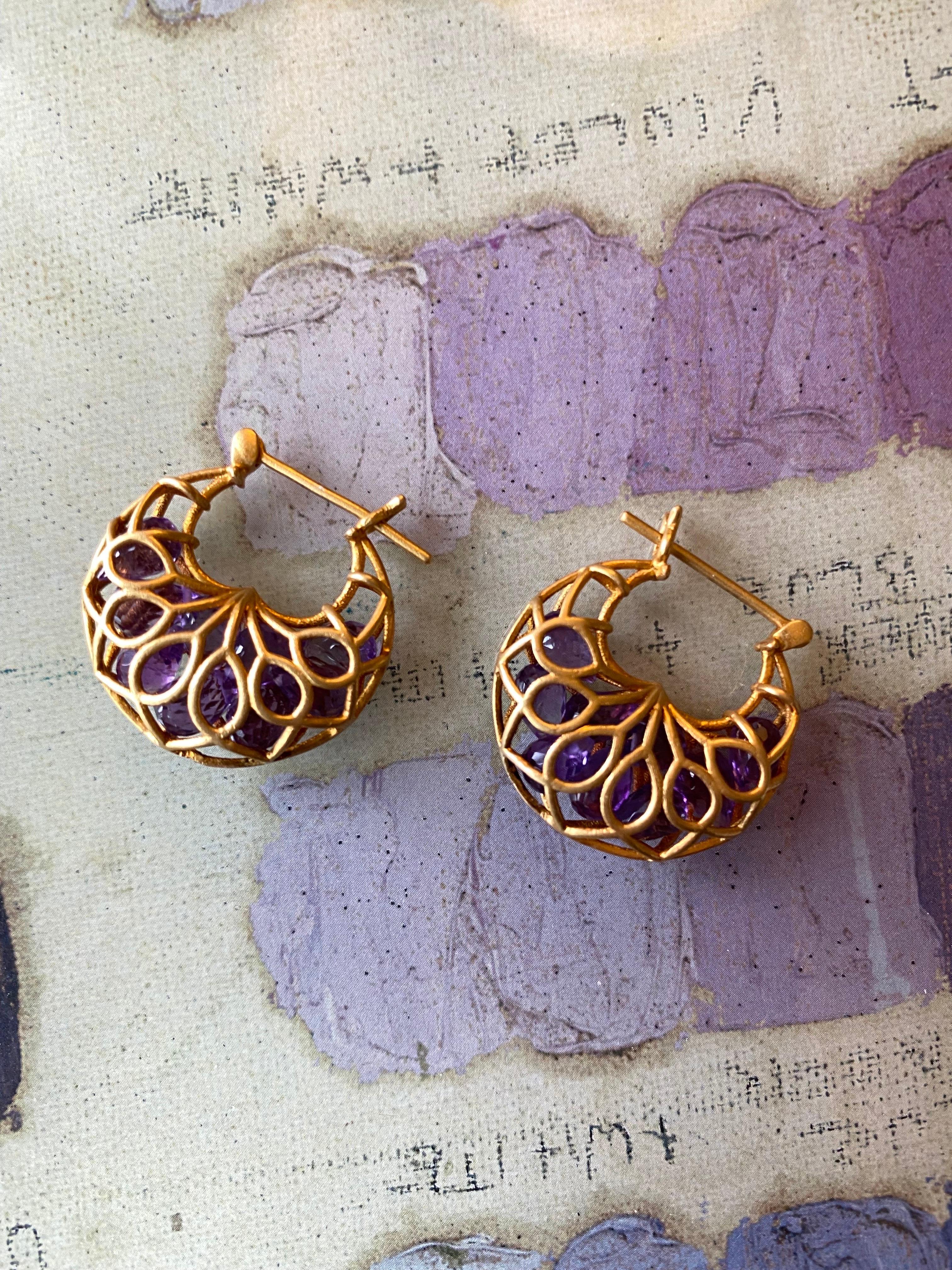 Amethyst drops float inside these 18kt Gold Cage Lauren Harper Hoops.  Lightweight but a big look.  Stones sparkle with a beautiful Amethyst hue from within the cage.  Ships directly from original designer and creator, Lauren Harper, in beautiful