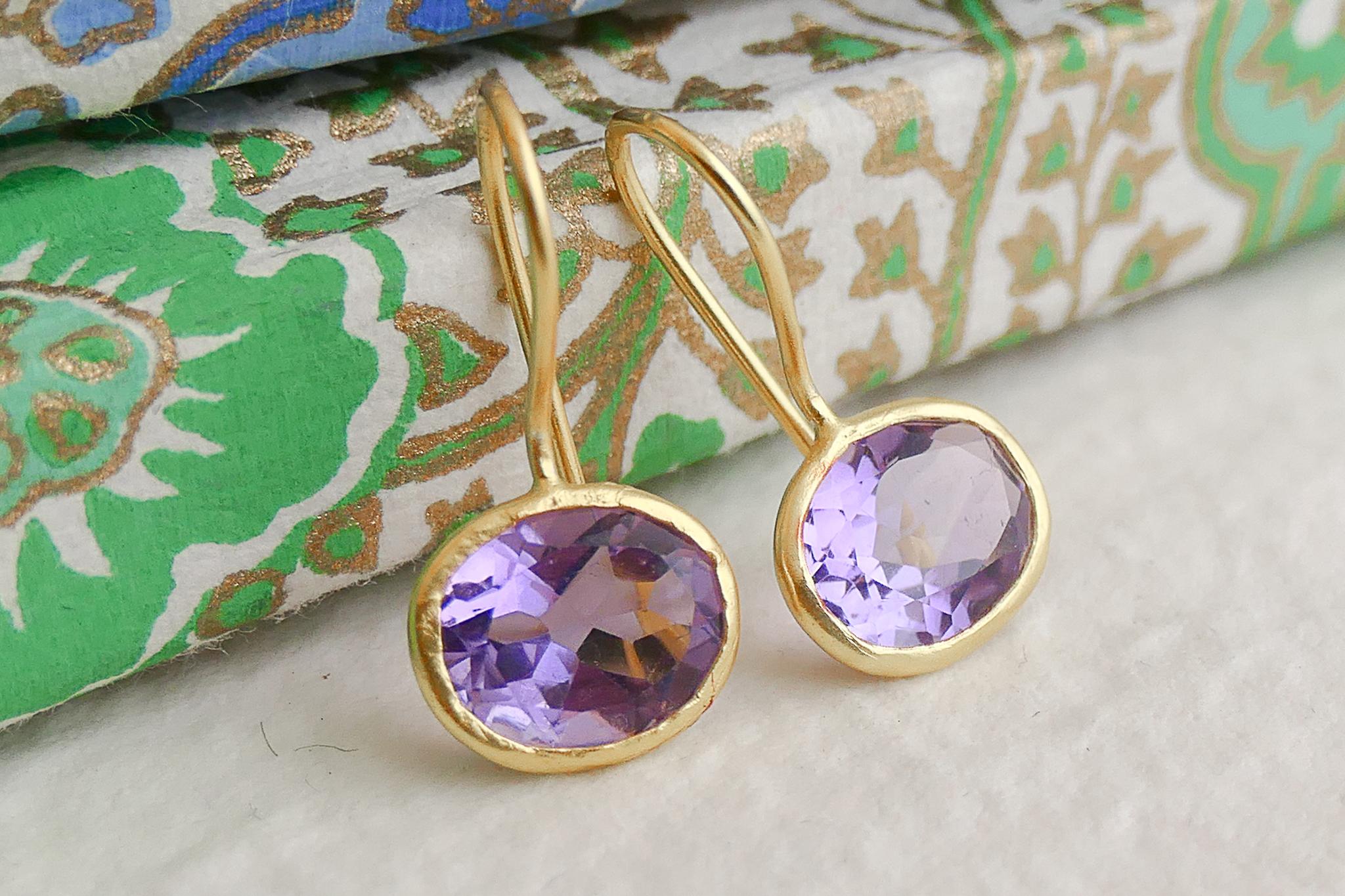 7x9mm faceted oval cut amethyst  set in gold plated sterling silver and placed in gold plated sterling silver  earwires.

✦Gemstone:  amethyst
✦Stone Cut: faceted oval  cut
✦Stone Size: Approximately 7x9mm
✦Size of earring from top of earwire is