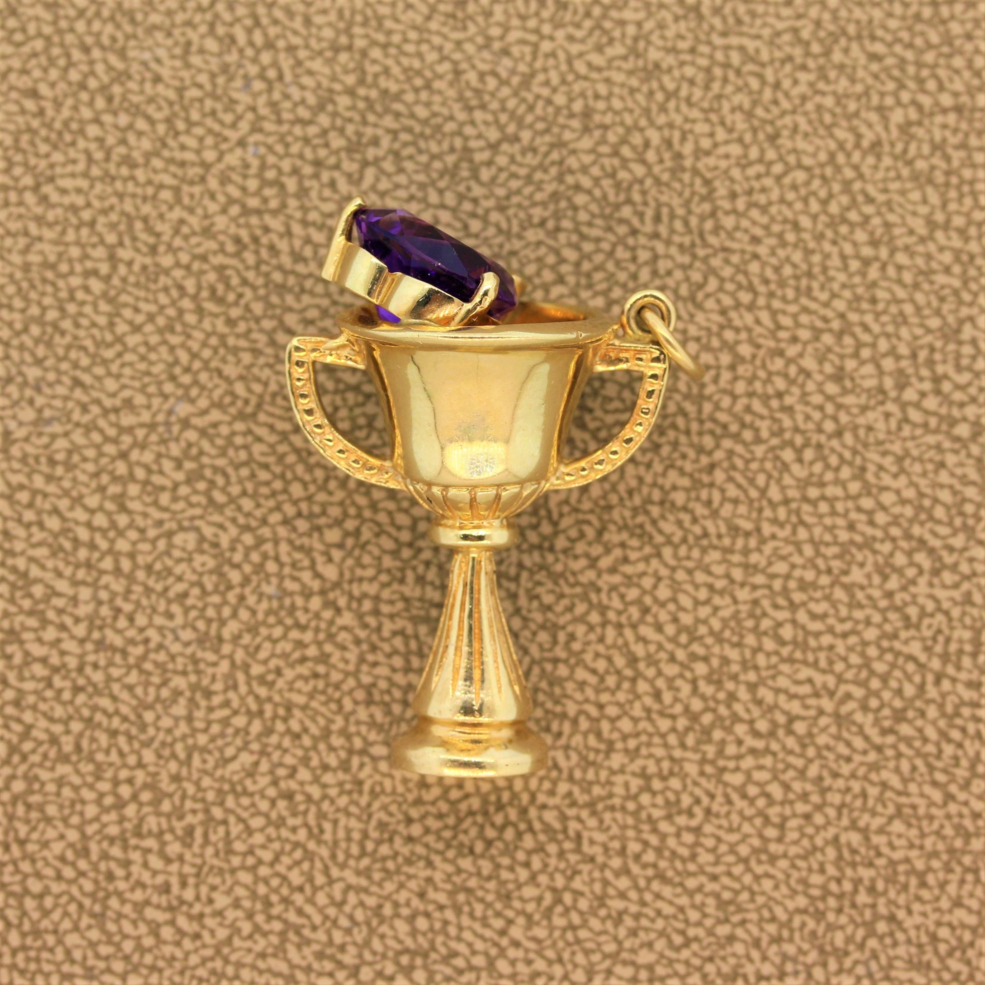 This one’s a winner! A trophy made of 14K yellow gold with a royal purple trillion cut amethyst by its edge. This champion’s pendant can just as easily be worn on a charm bracelet to suit any outfit.

Pendant Length: 1.30 inches
Pendant Width: 0.95