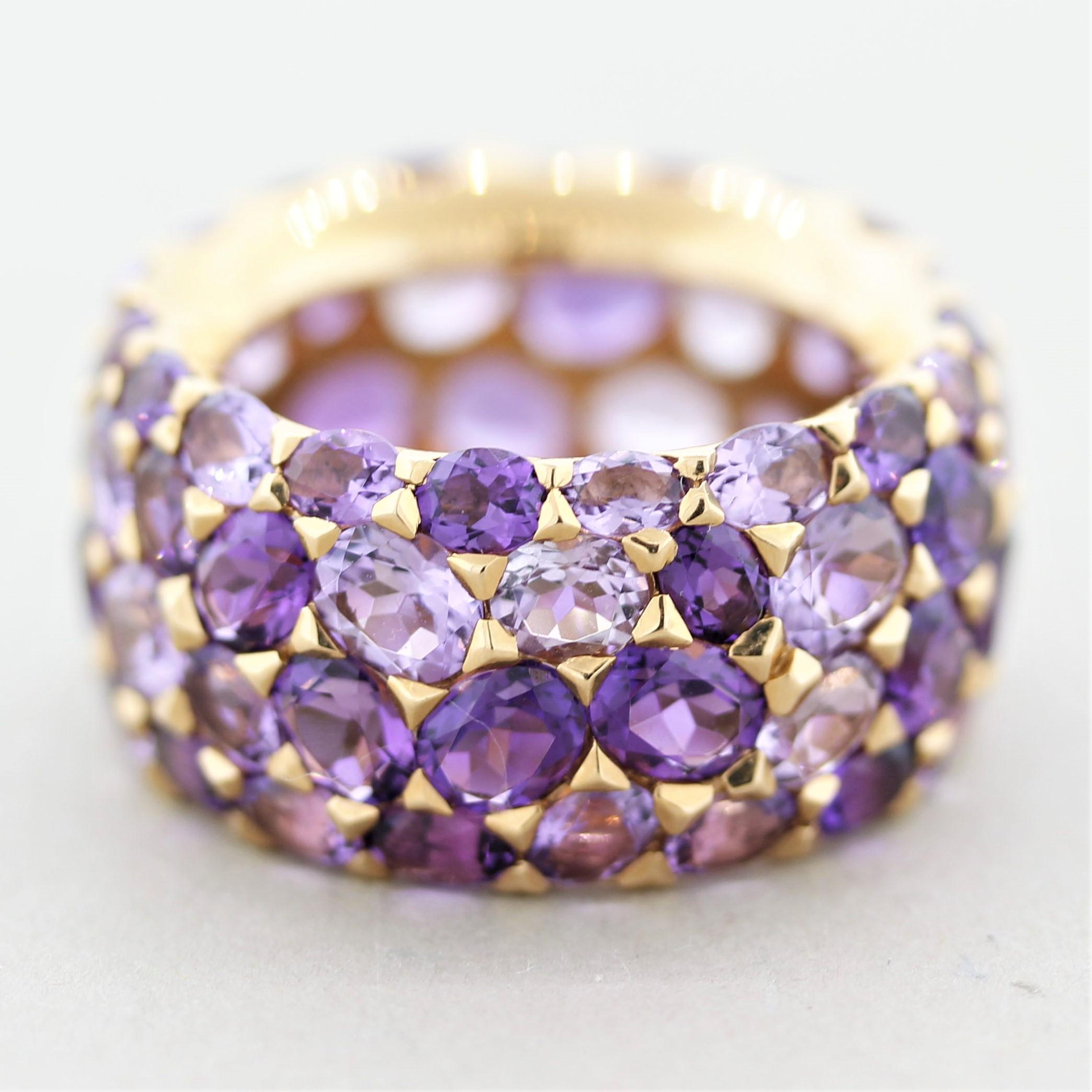 A modern and stylish wide eternity band featuring 12.90 carats of amethyst of light and dark colors. All the stones are oval shapes but half of them are a lighter pinkish-purple while the other half is a deeper royal purple color. The contrast gives