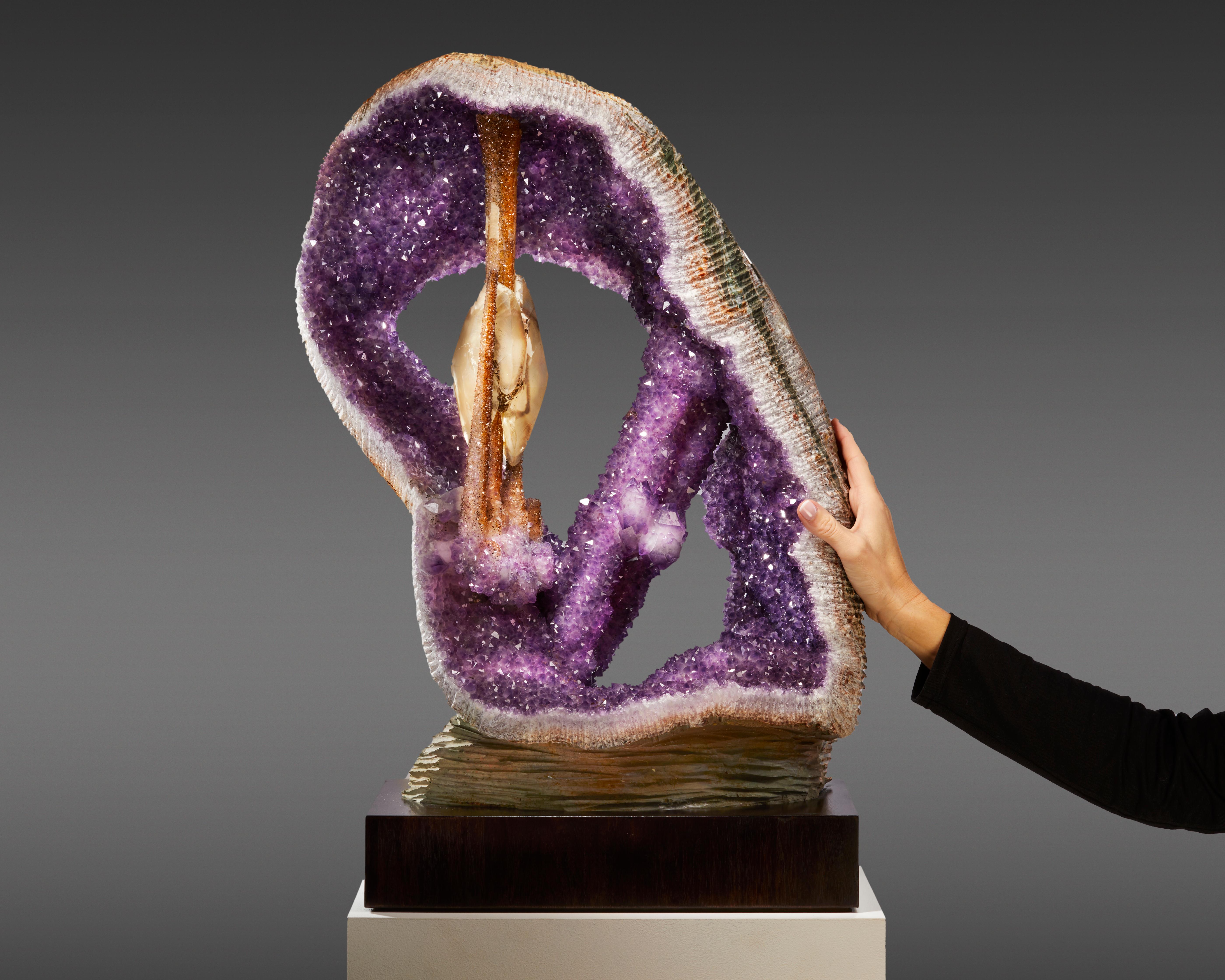 This museum-quality Amethyst “harp” from Artigas, Uruguay, is a natural sculpture of exceptional beauty and rarity. The piece features a harmonious arrangement of high-quality Amethyst crystals, forming an open, loop-like structure reminiscent of a