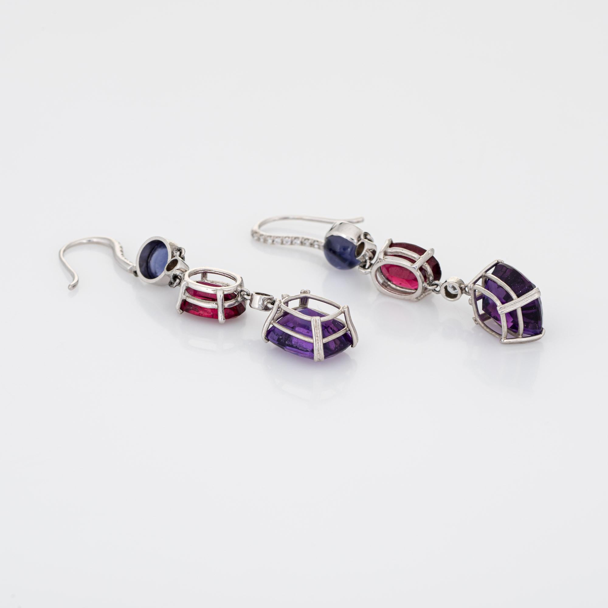 Stylish pair of amethyst, iolite and rhodolite garnet & diamond earrings crafted in 18k white gold. 

Two amethysts measure 10.5mm x 9mm (estimated at 3.75 carats each - 7.50 carats total estimated weight), two rhodolite garnets measure 9.5mm x 7mm