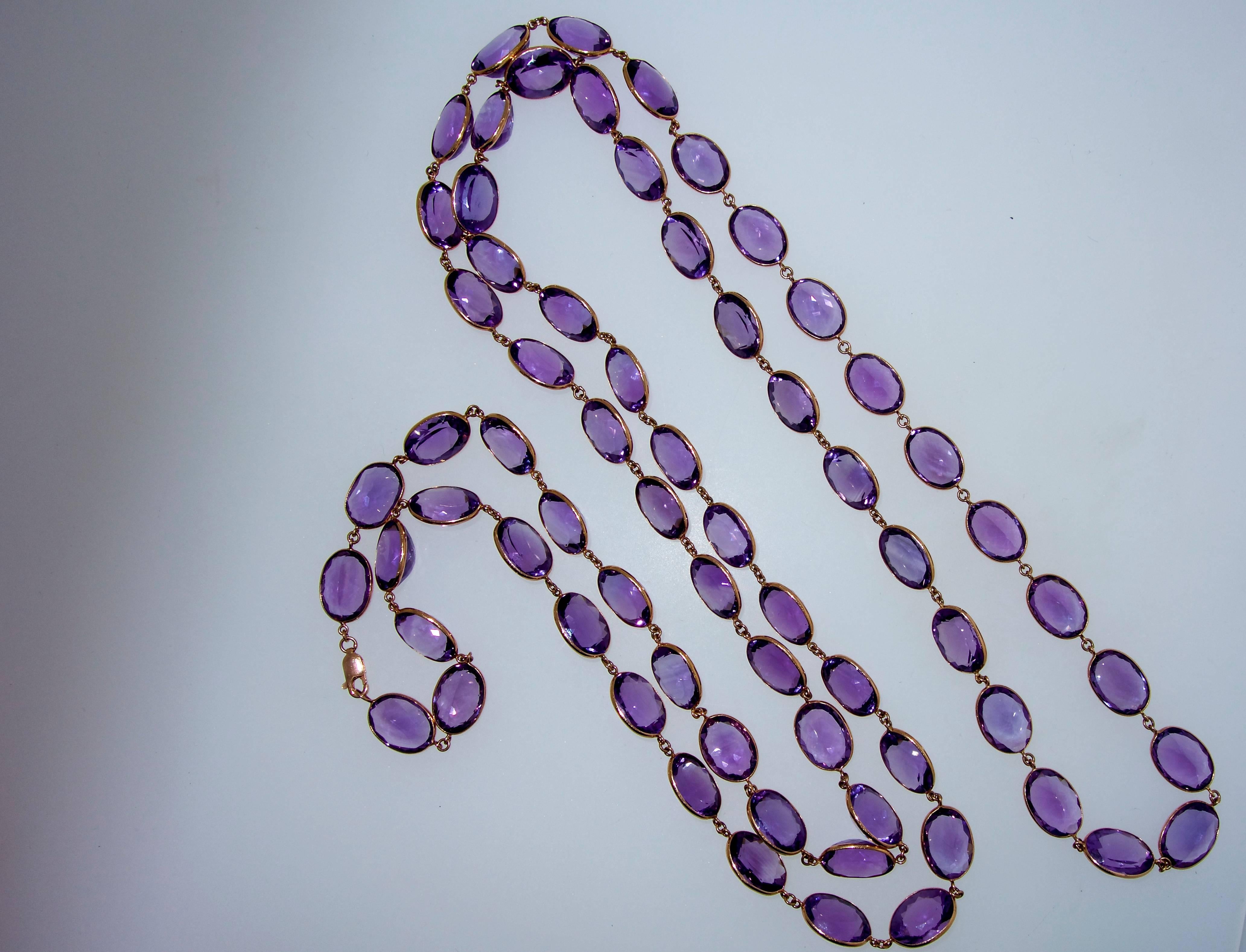 Long pink or rose gold chain, over 60 inches, which can be worn a variety of wrapped length has 68 fine bright purple amethysts which average 7 cts. each totaling an approximate amethyst carat weight of 475 cts.