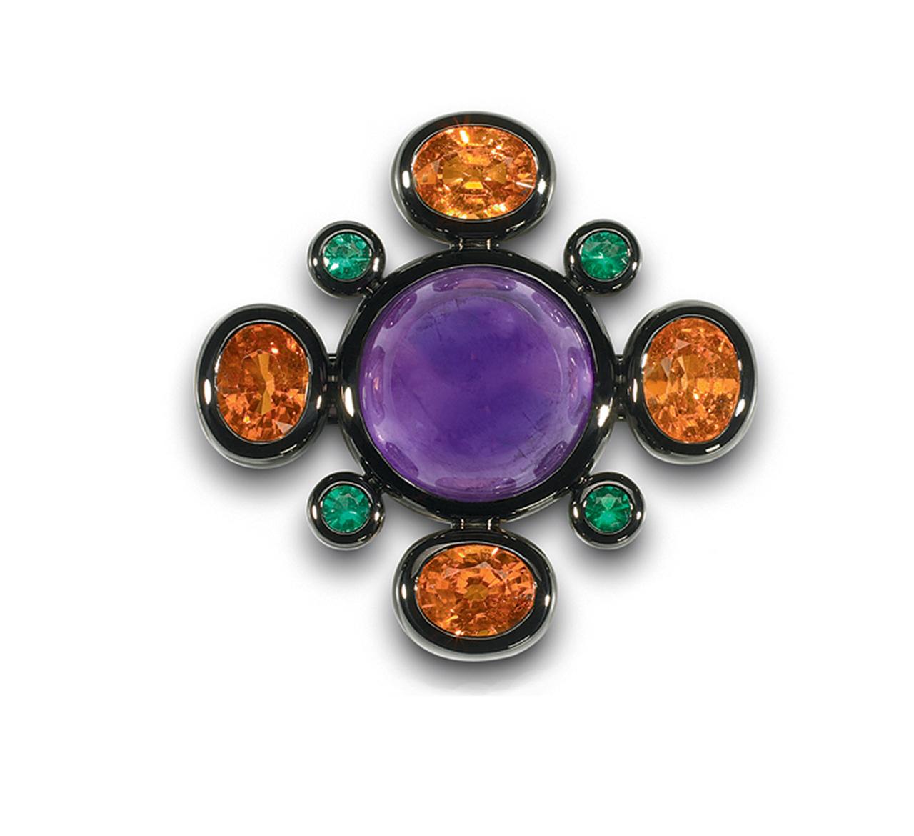 Stunning Colleen B. Rosenblat Brooch with one large 26.89 Carat Amethyst and 4 Mandarine Garnets 16.25 Carat and 4 Emeralds 0.66 Carat each.
This Brooch is made of 18 Carat blackened white gold and can also be worn as a Pendant on a chain.