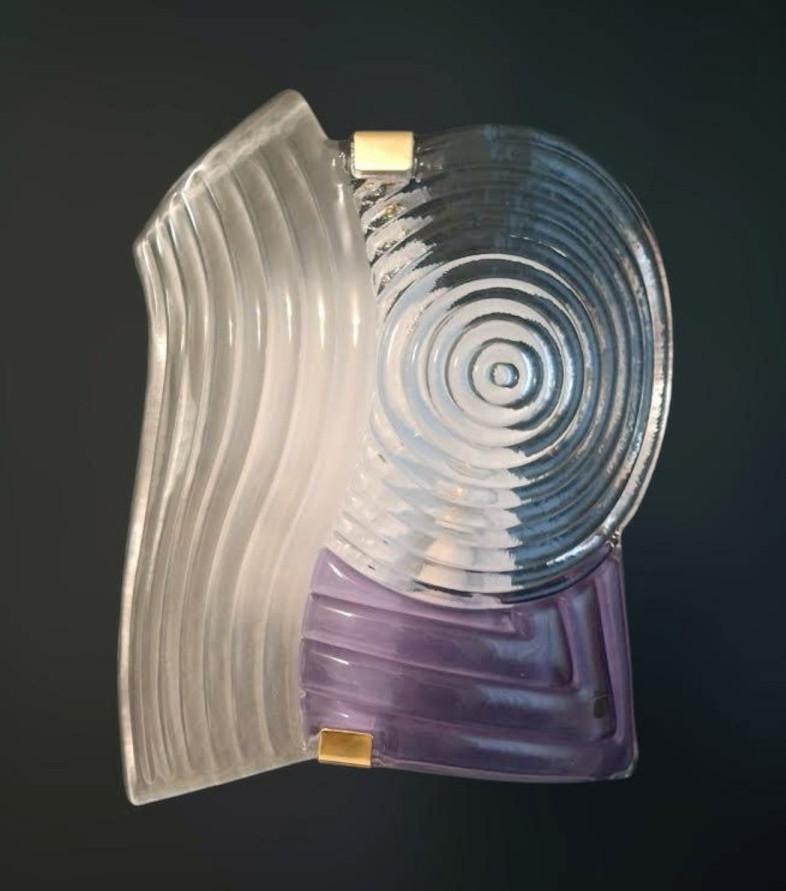 Vintage Italian wall light with a large clear and amethyst Murano glass shade hand blown in grooved texture / Made in Italy by ITRE, circa 1960s
Original label on the glass
Measures: height 16 inches, width 12 inches, depth 3.5 inches
2 lights / E12