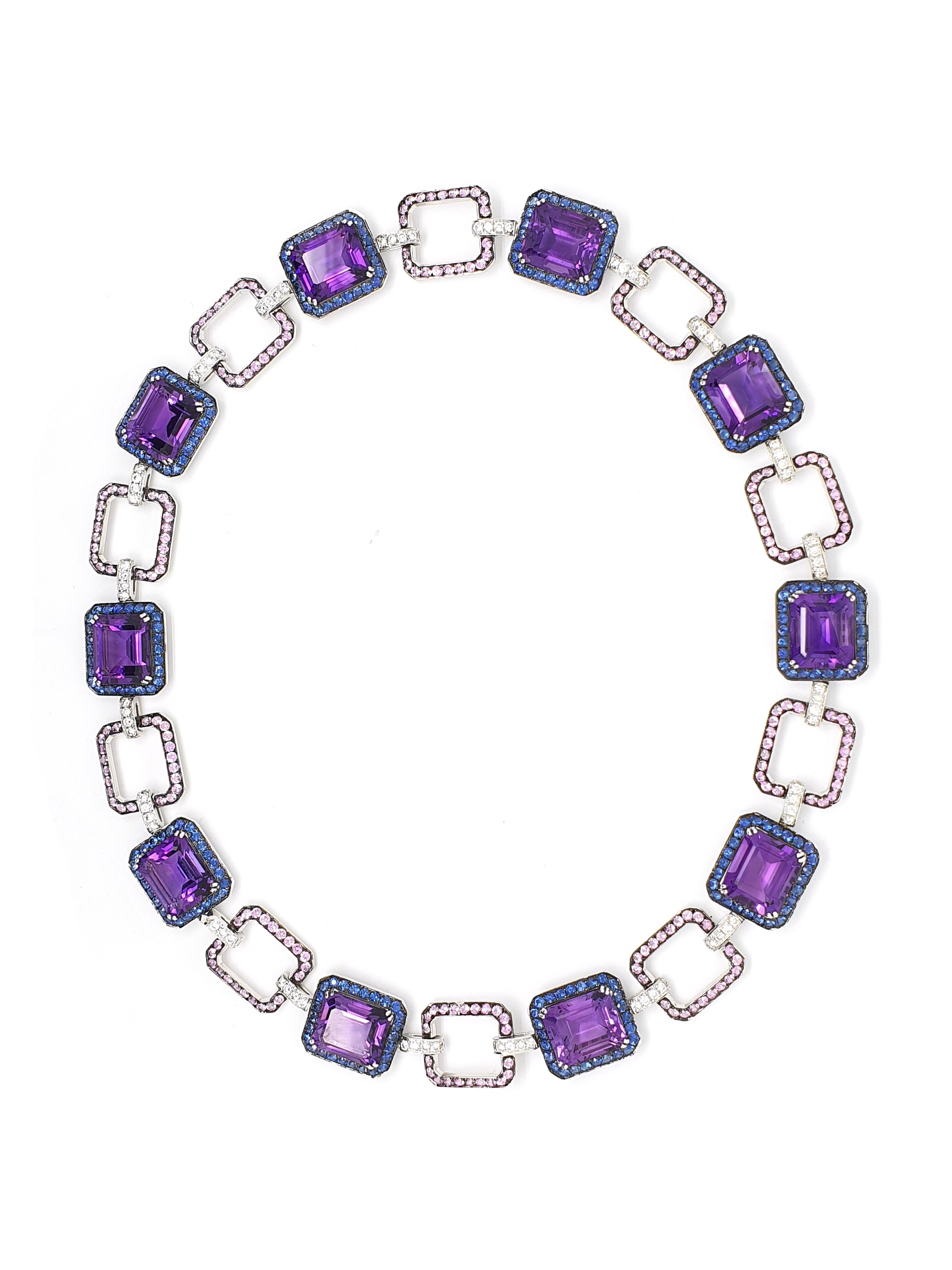 An 18K white gold necklace with 54.41ct, 8-angular sharpened Amethyst, 7.65ct, blue-lilac Korunden, 6.35ct pink 	Corunds, 1.95ct brilliantly sharpened diamonds colour W and clarity VVS. Rose gold weight 52.41 grams.	