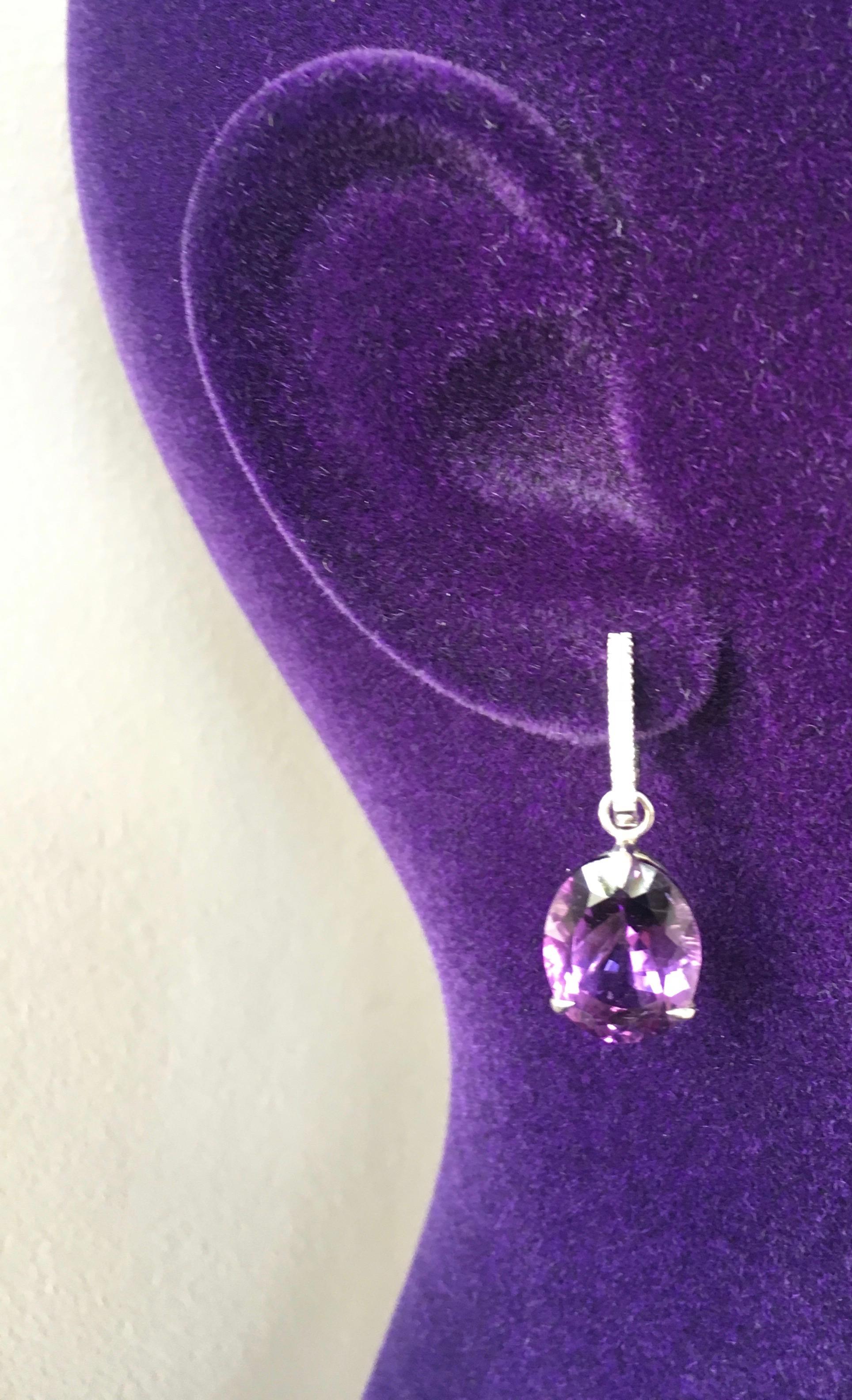 Oval cut intense purple amethyst drops hang from a pair of 18 Karat gold pave set diamond oval hoops.  The drops are detachable, the hoops can be worn on their own or with other gemstones or pearls. 

Diamond oval hoops 0.20 cts. F/VVS
Amethyst: