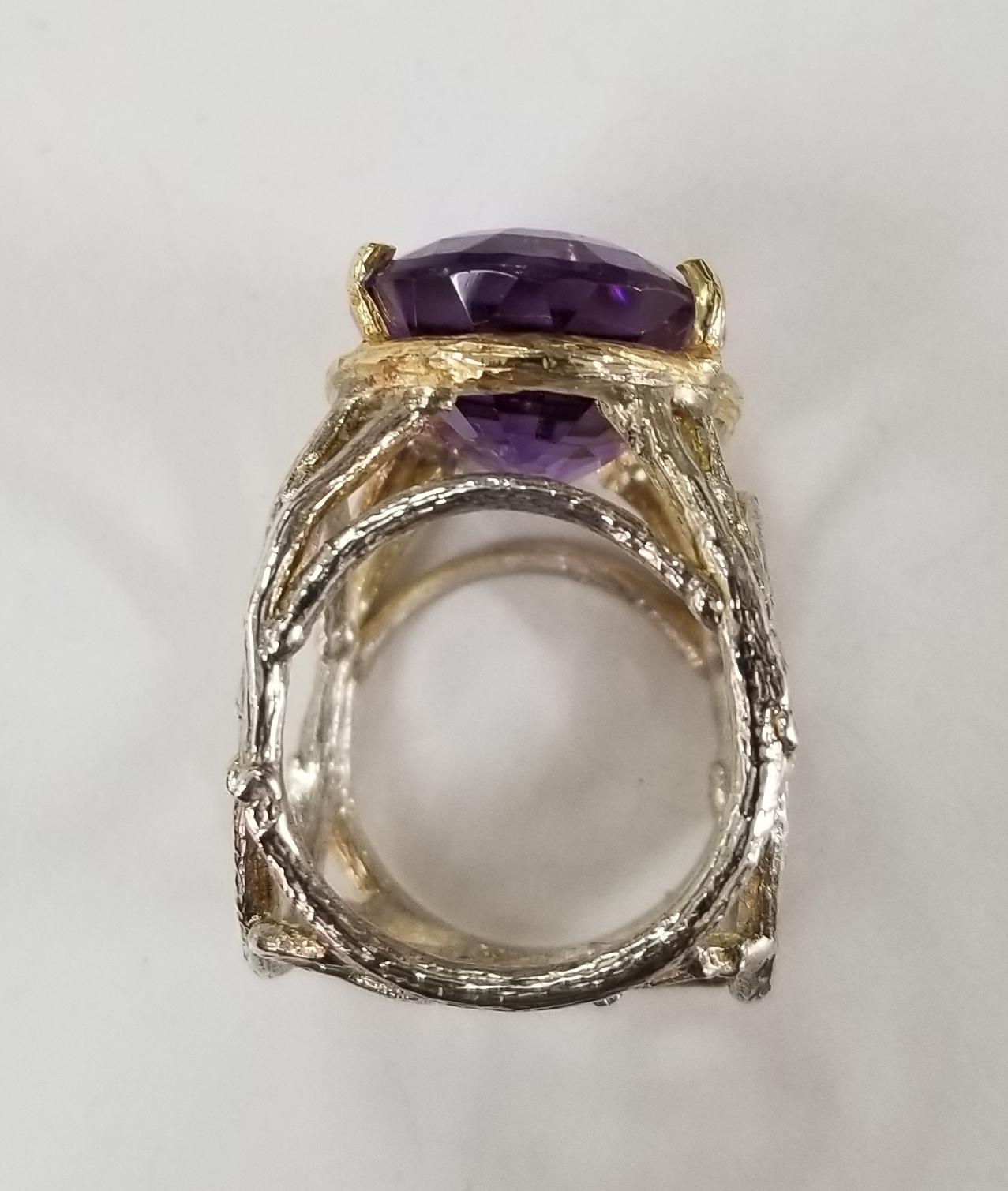 Amethyst oval 21.83cts. 14 karat yellow gold and silver, containing  and 1 large oval amethyst weighing 21.87cts.  The ring is made to fit 2 different fingers size 6 and 8.