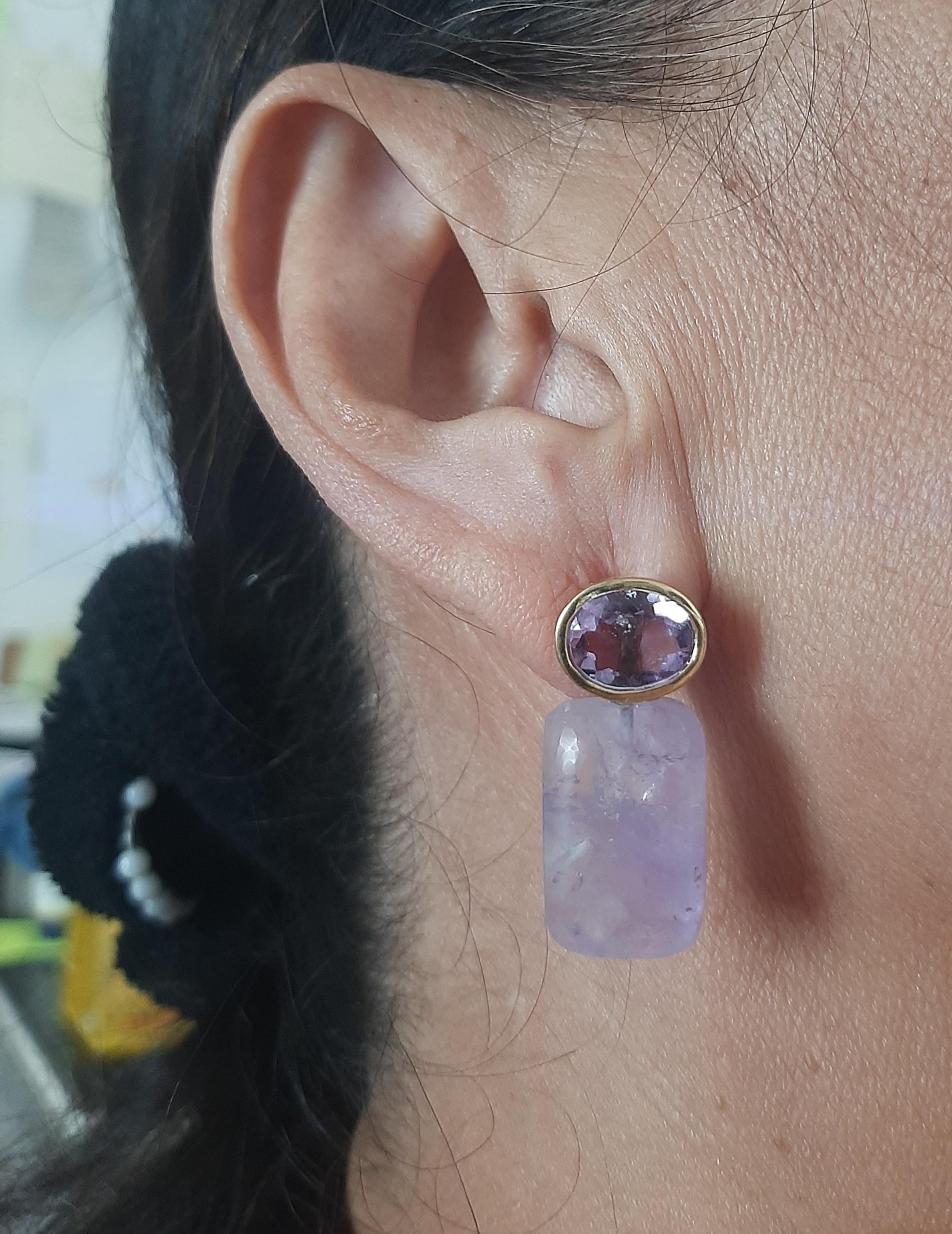 These simple but elegant and handmade earrings have 2  Faceted Oval Amethyst measuring 8 x 10 mm set in a 14 Kt yellow gold bezel at the top to which are suspended 2 Amethyst Rectangular Shape Cabs measuring 13 x 18 mm.

In 1978 our workshop started