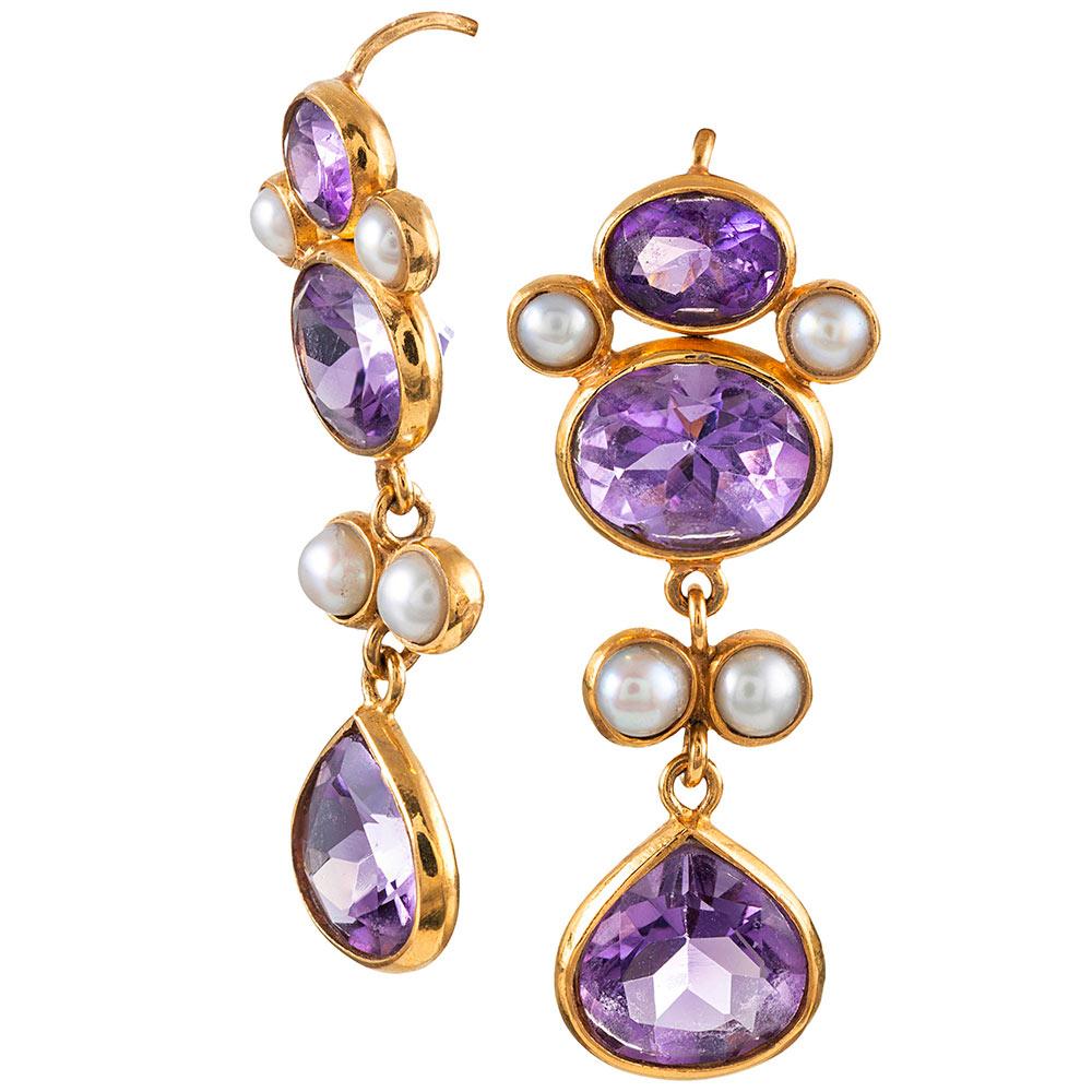Golden bezels of 22 karat surround faceted amethyst and lustrous pearls. The absence of diamonds allows these earrings to be worn for all occasions, while the gentle movement of the design allows light to dance within the stones. The earrings