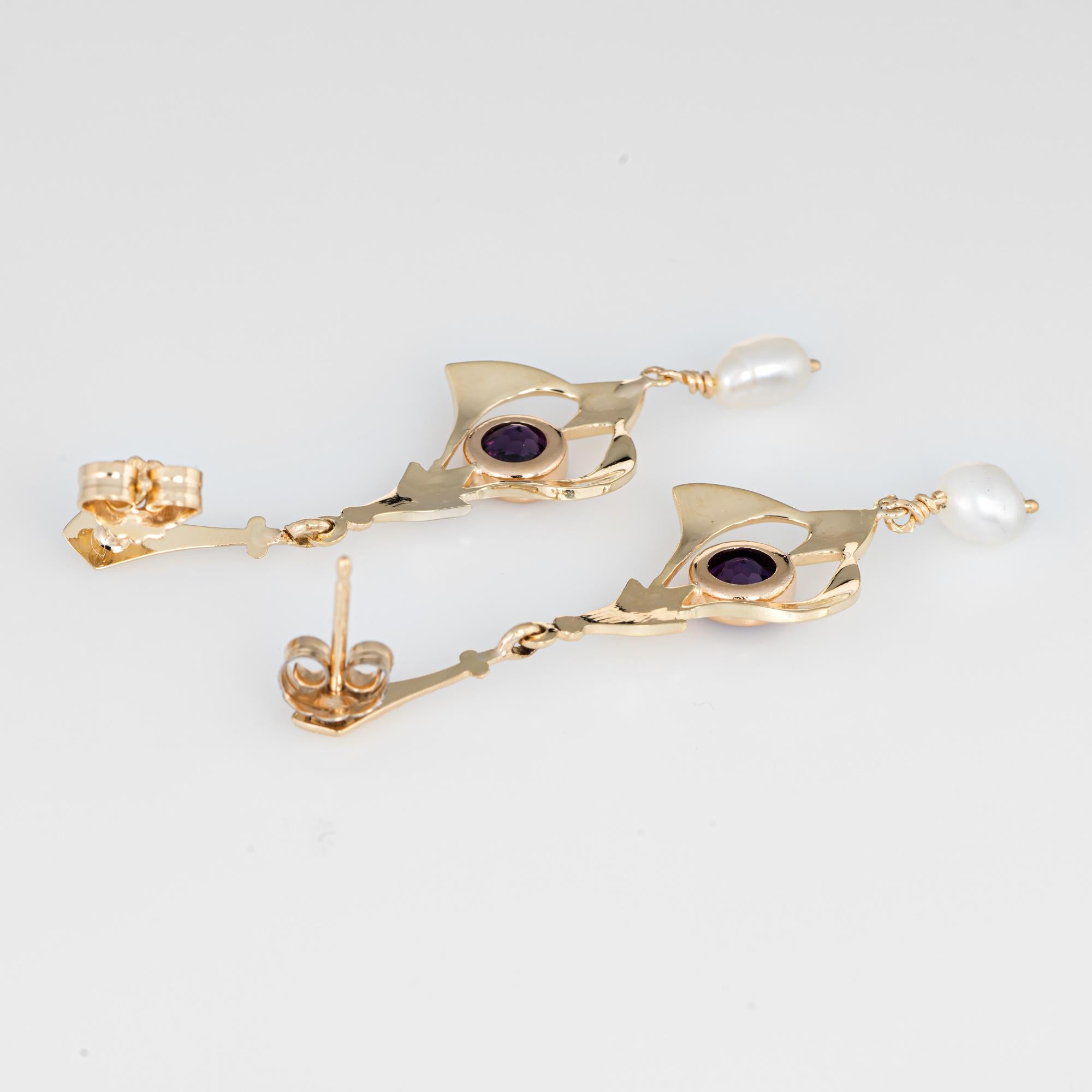 Elegant pair of vintage amethyst & freshwater pearl drop earrings crafted in 14k yellow gold. 

Two amethysts are estimated at 0.40 carats each (total estimated weight of at 0.80 carats), accented with two estimated 4.5mm freshwater pearls. The